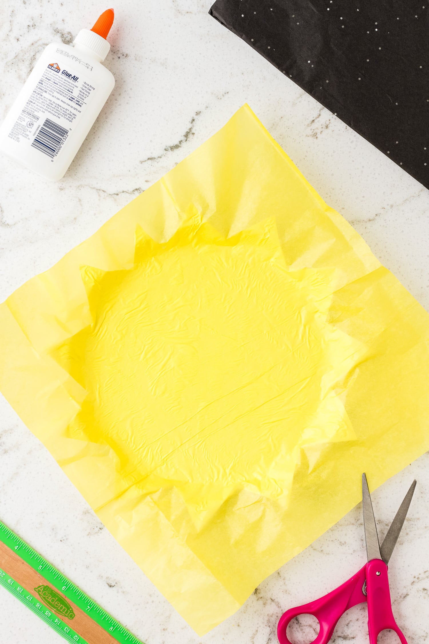 Yellow tissue paper glued to paper plate