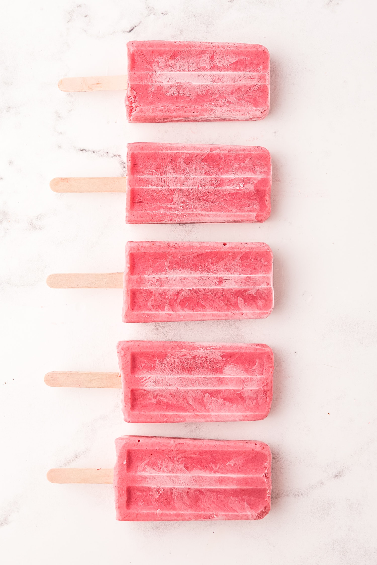 Overhead image of strawberry banana popsicles