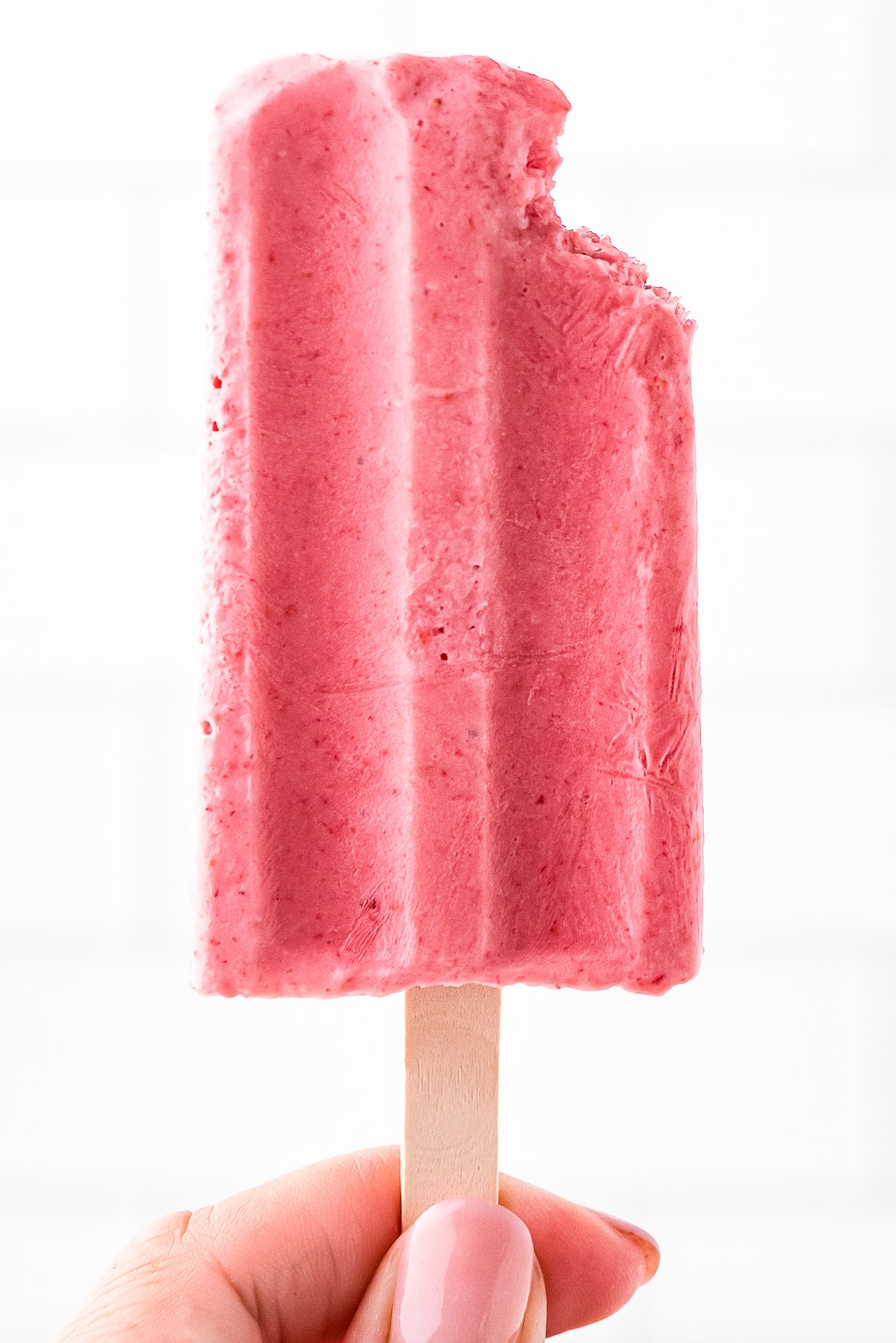 Strawberry Banana Popsicle held by a hand