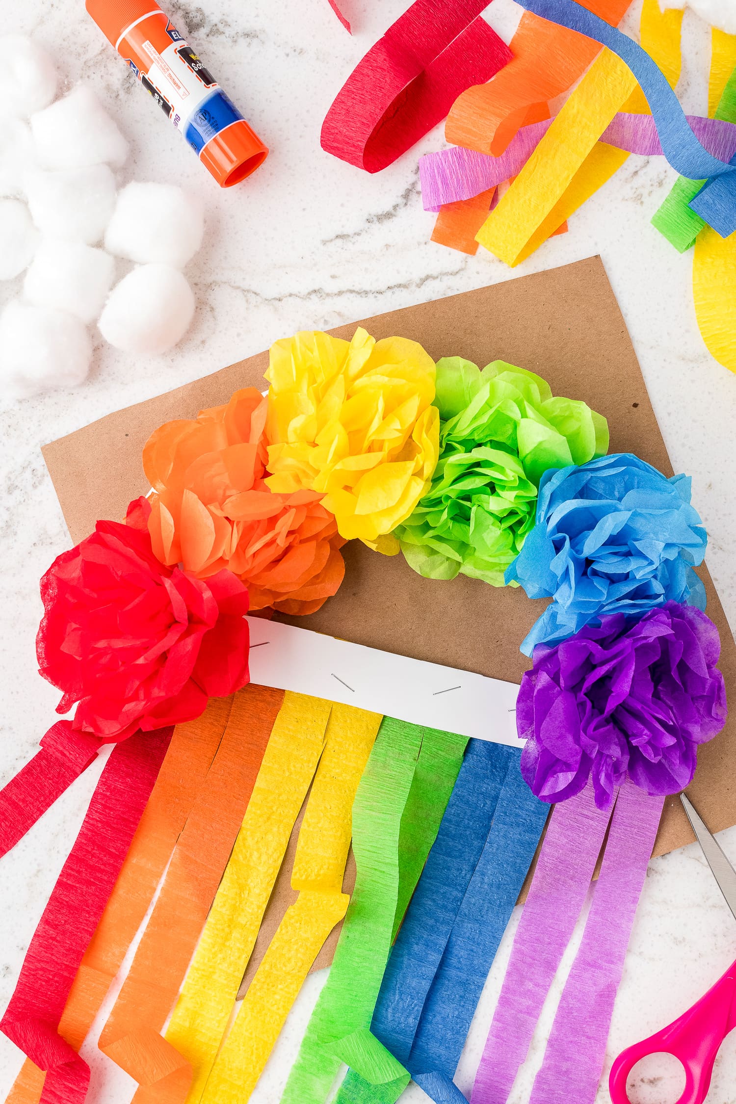 Cut tissue paper streamers on rainbow craft