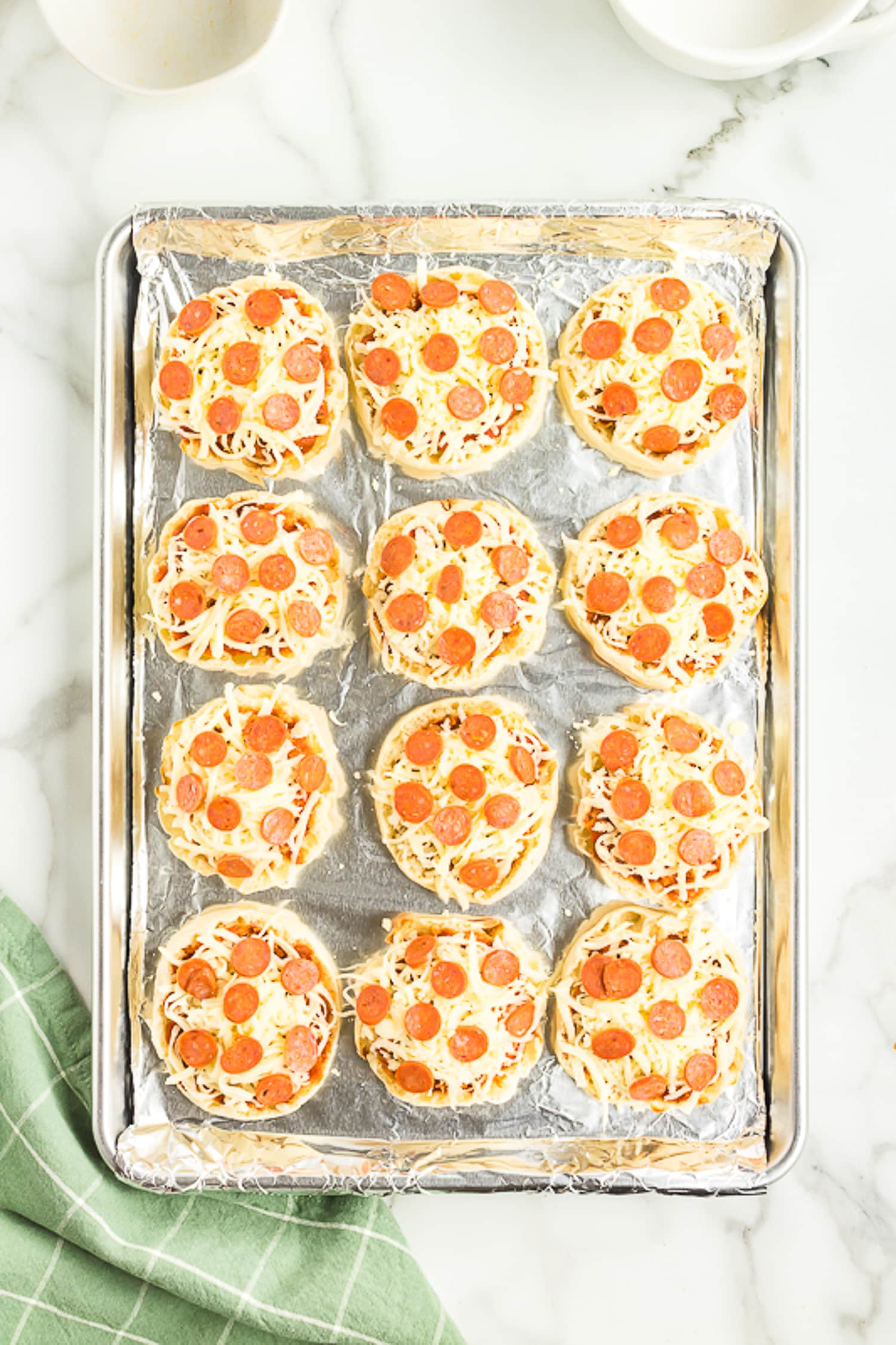 Sheet pan with English Muffin Pizzas before baking