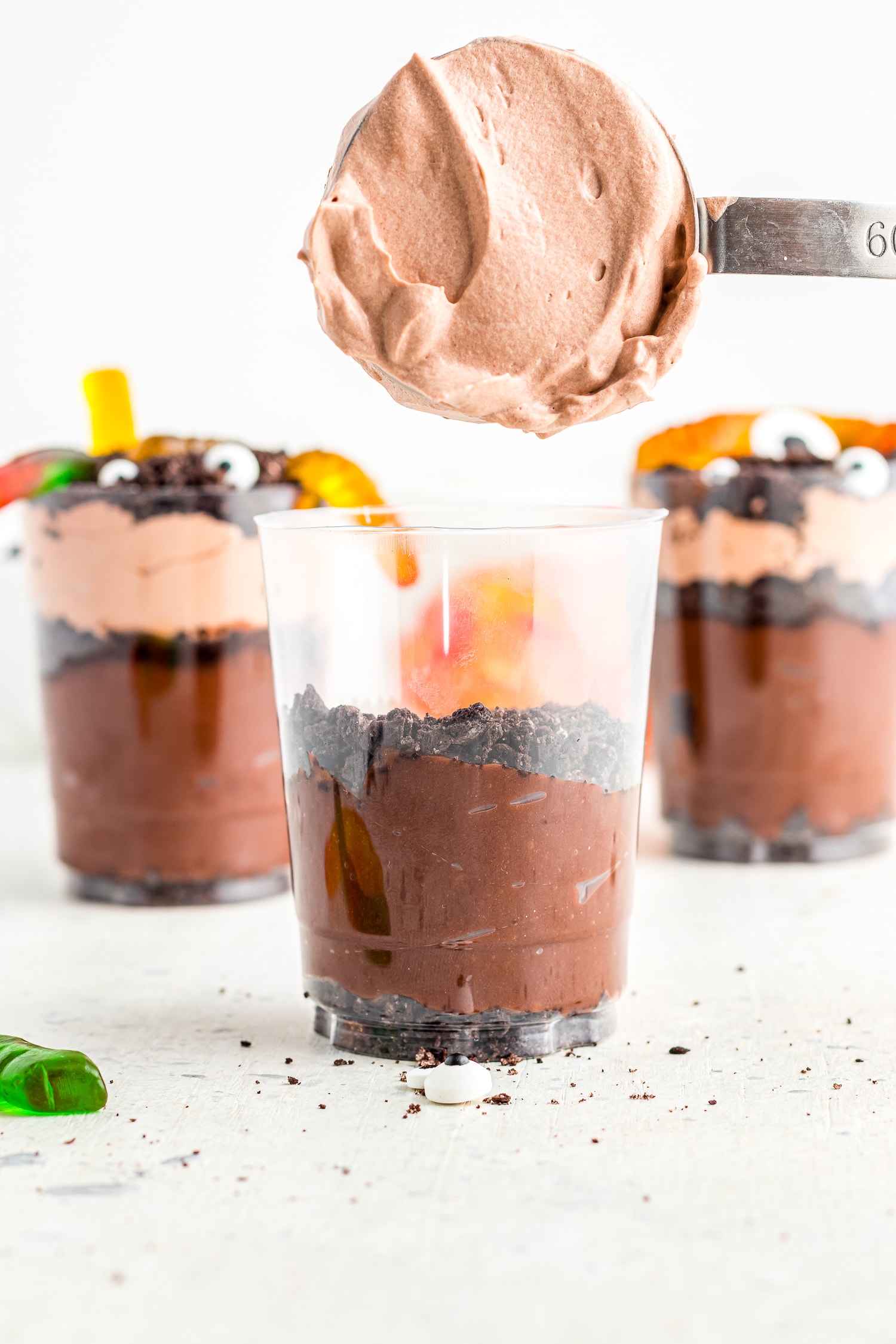 Spooning chocolate pudding into dirt cup