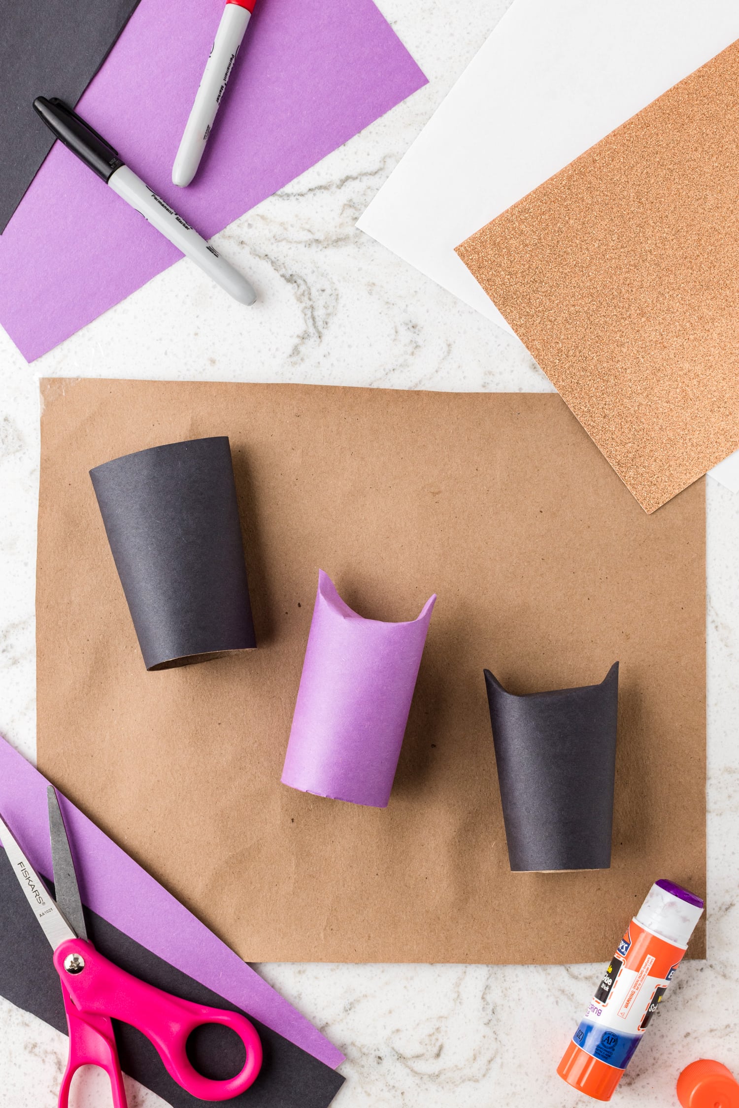 Sections of paper towel roll covered in purple and black paper