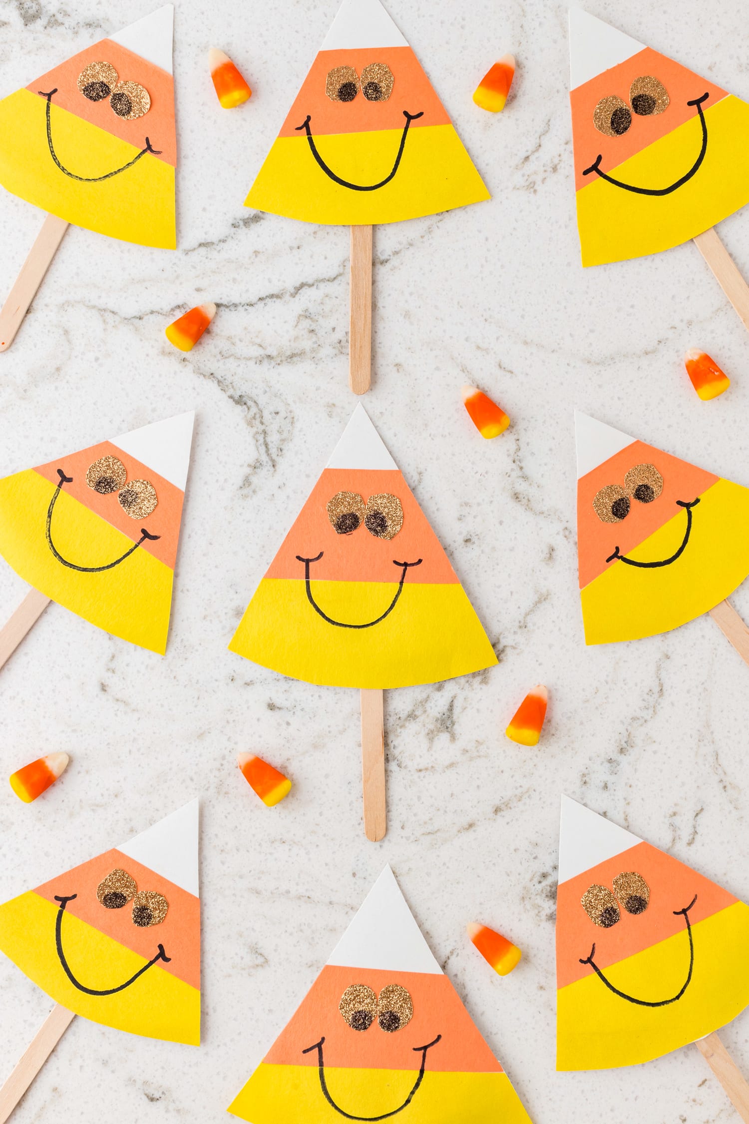 Quartz background with candy corn craft on popsicles sticks