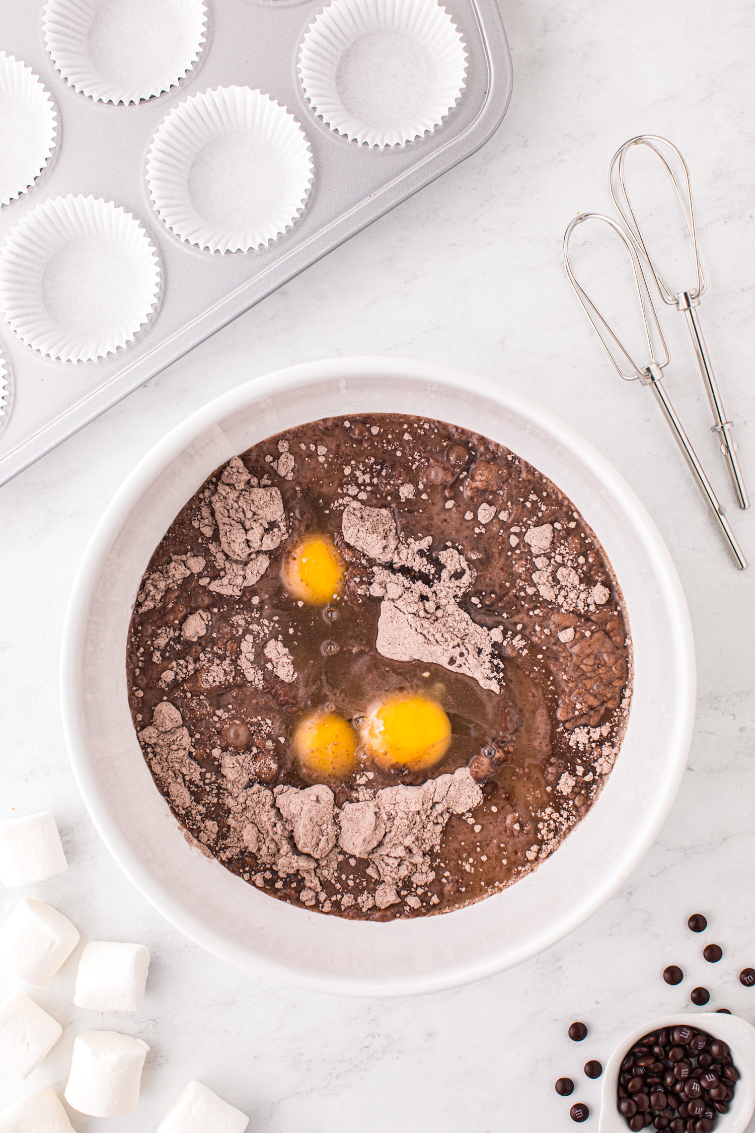 Bowl with chocolate cake mix and eggs