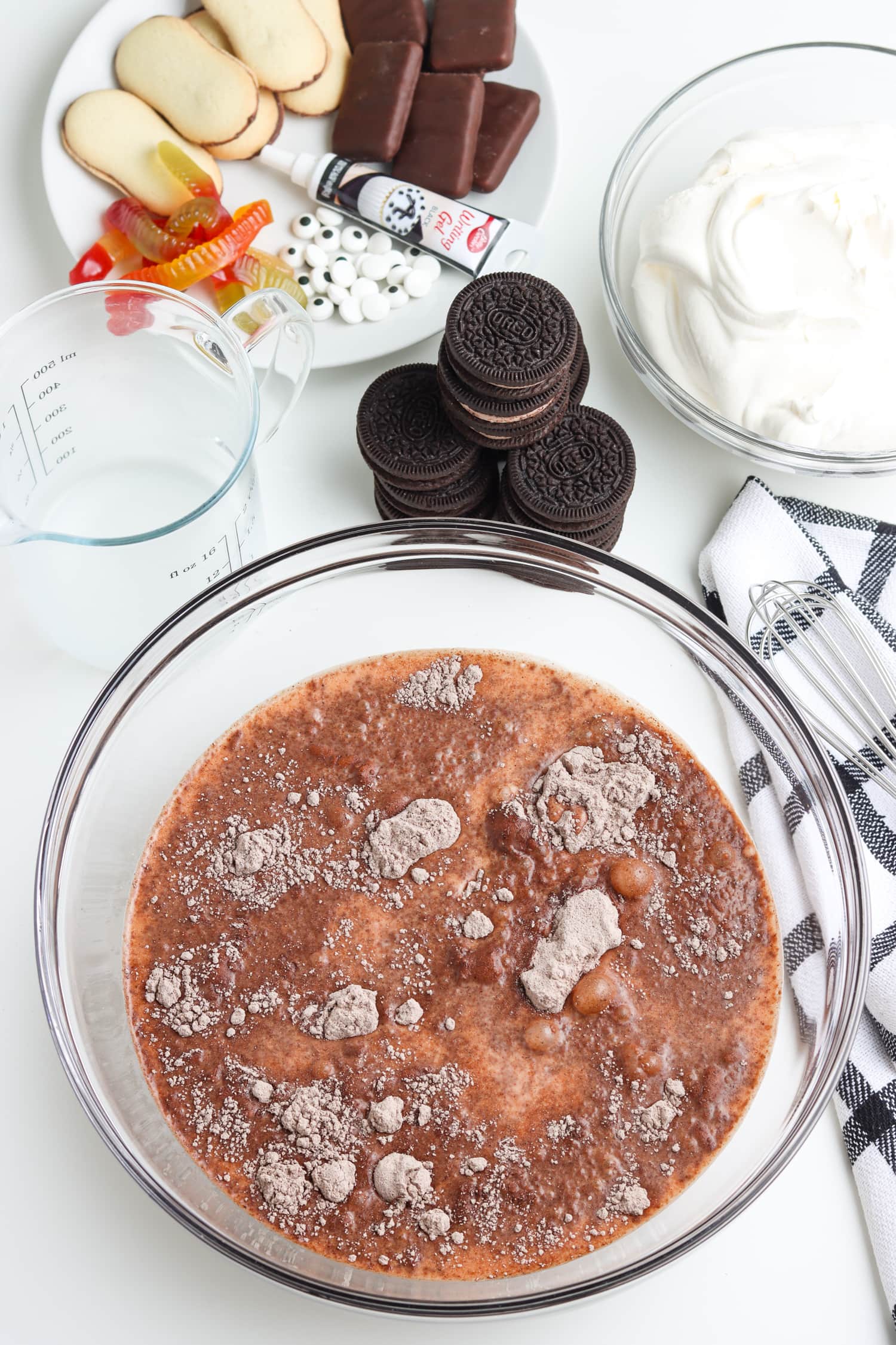 Glass bowl with instant chocolate pudding mix and milk