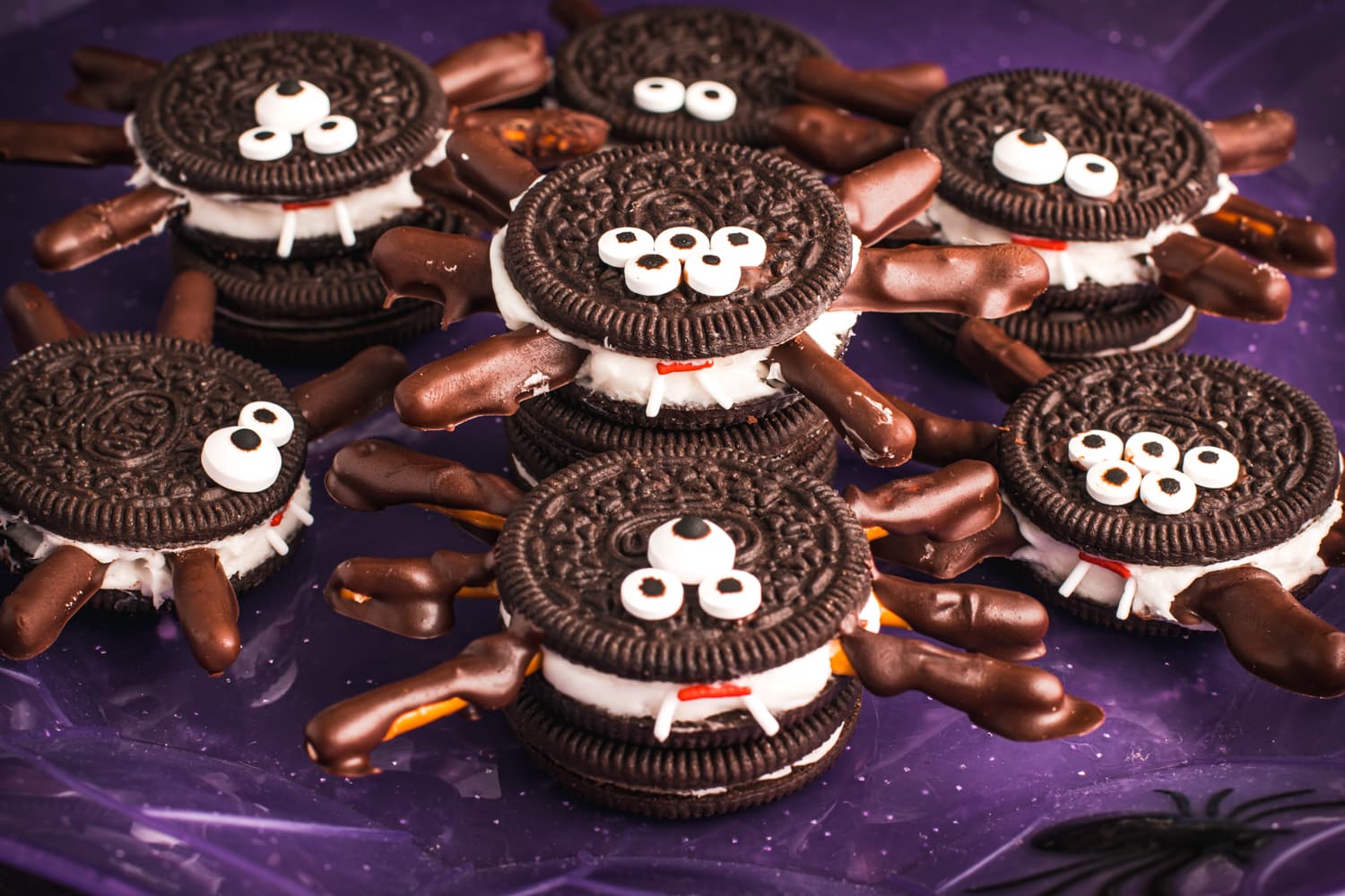 A purple plate with Spider Oreo Cookies
