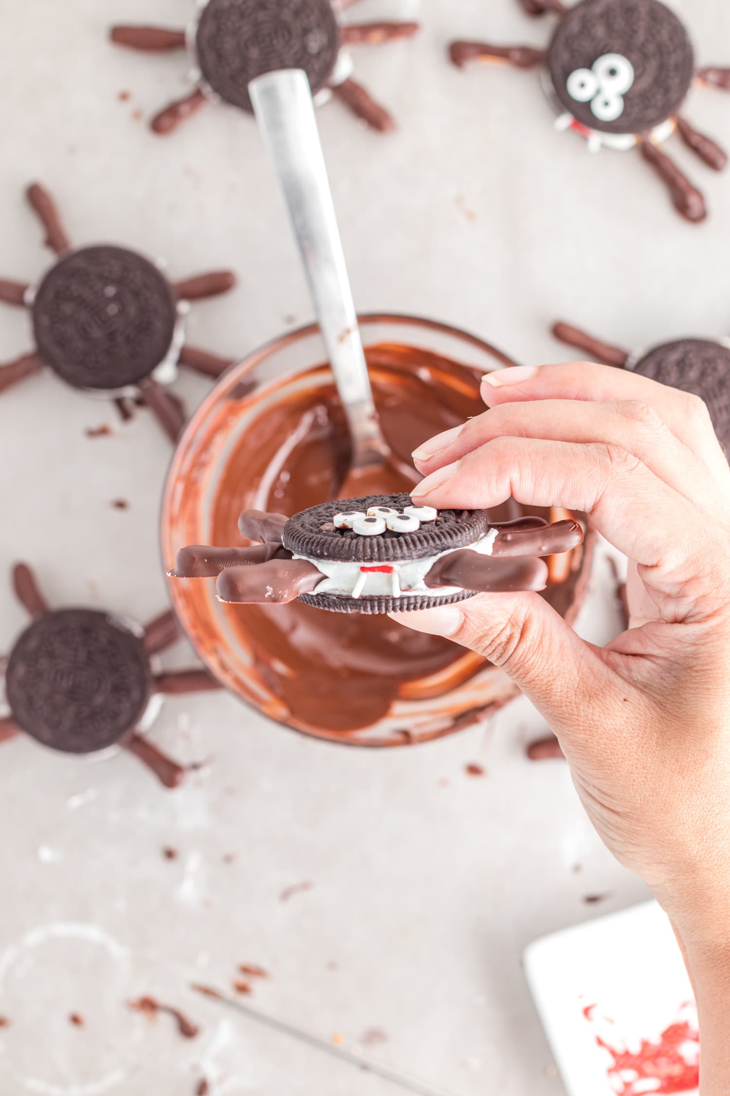 Hand holding Oreo Spider Cookies