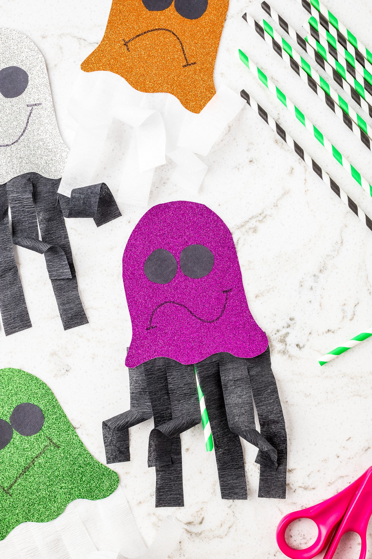 Purple glittery ghost craft on marble background