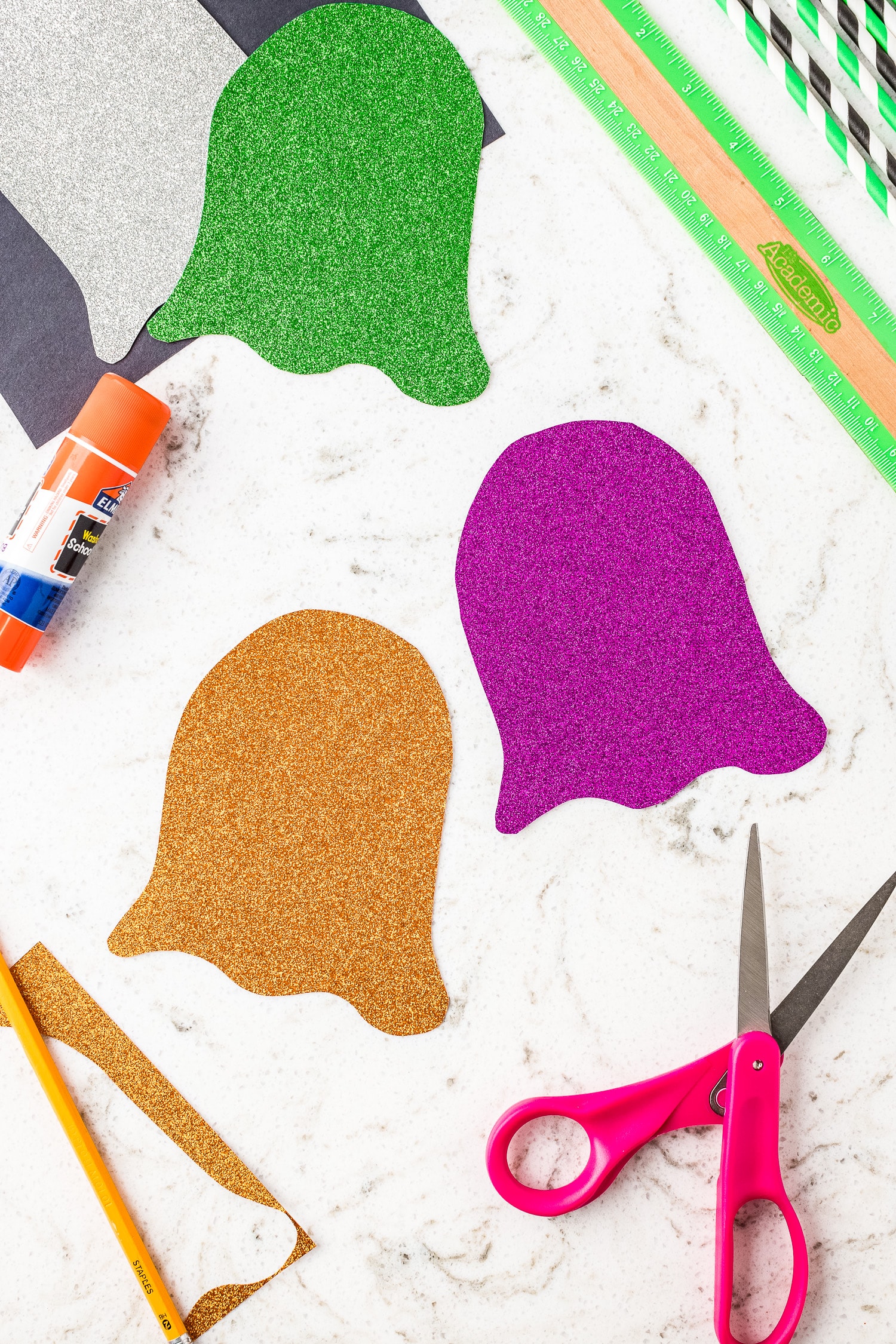 Ghost shape cut out of green, orange and purple glitter cardstock