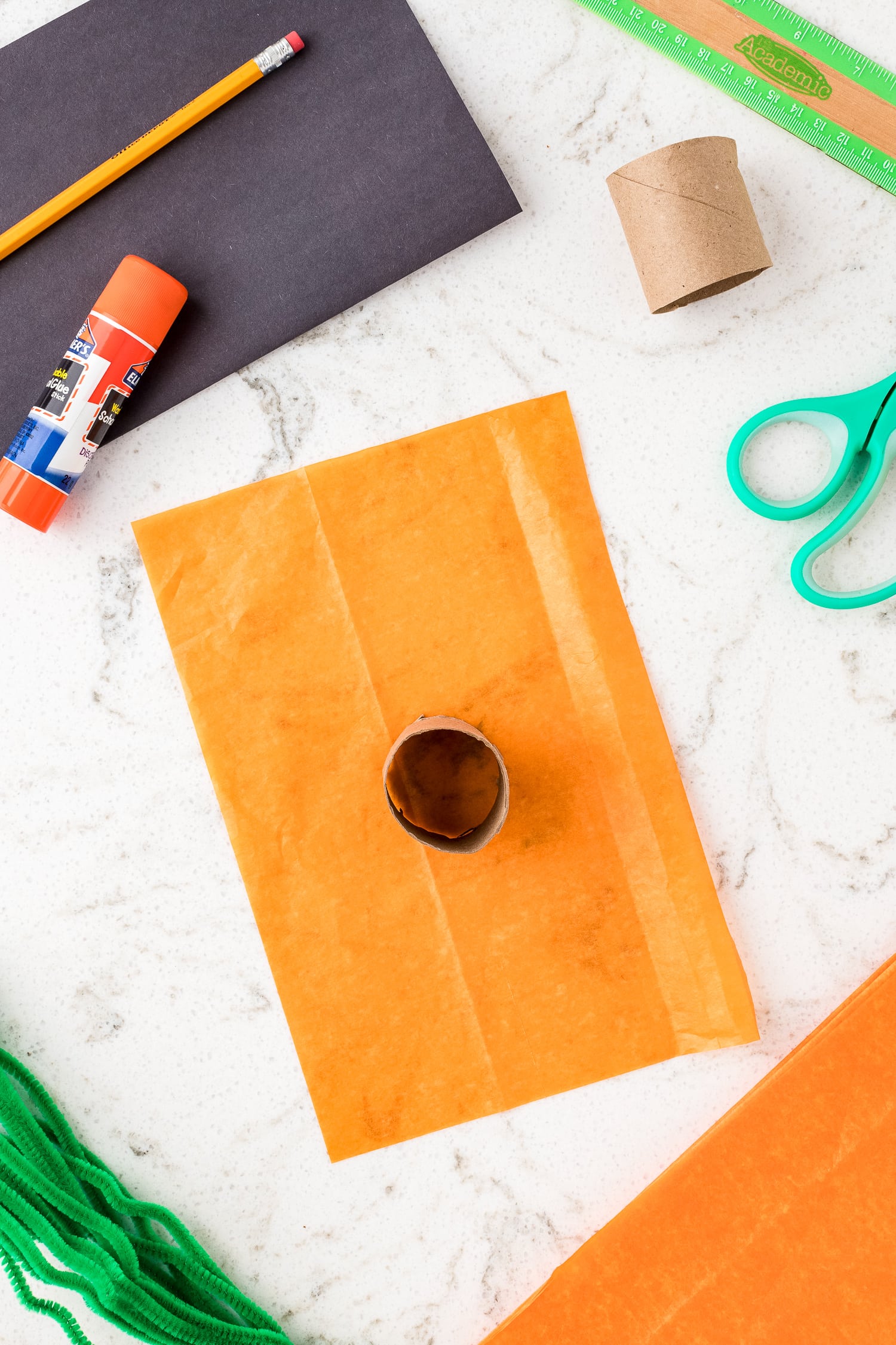 Toilet Pap Roll on top of orange tissue paper