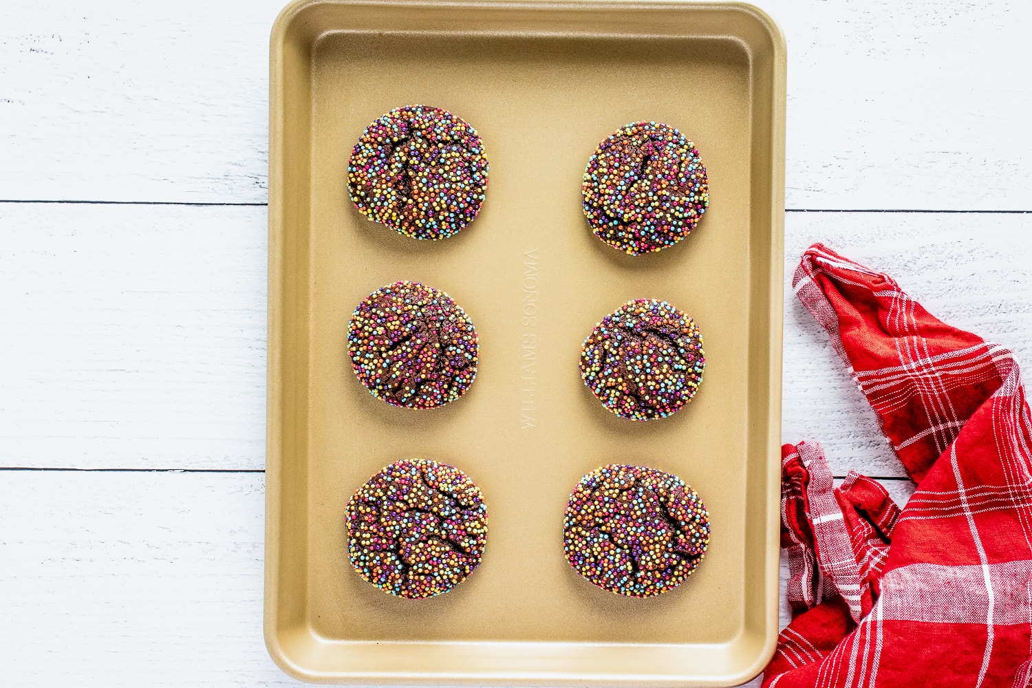 Gold sheet pan with baked chocolate sprinkle cookies