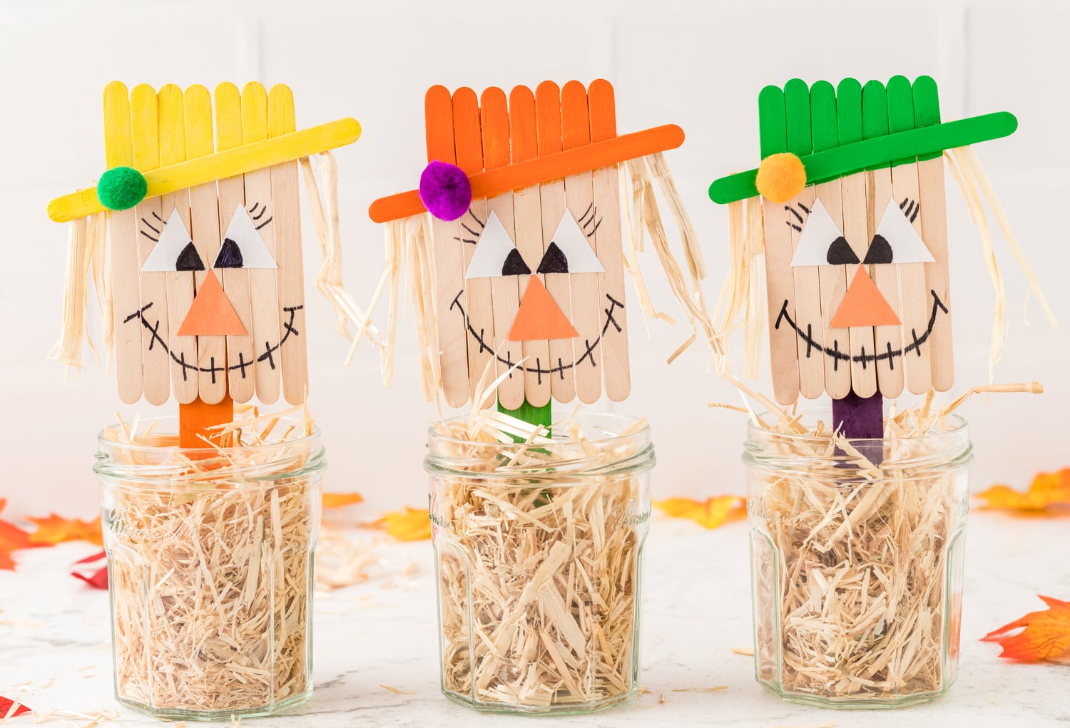 Three scarecrow crafts in mason jars