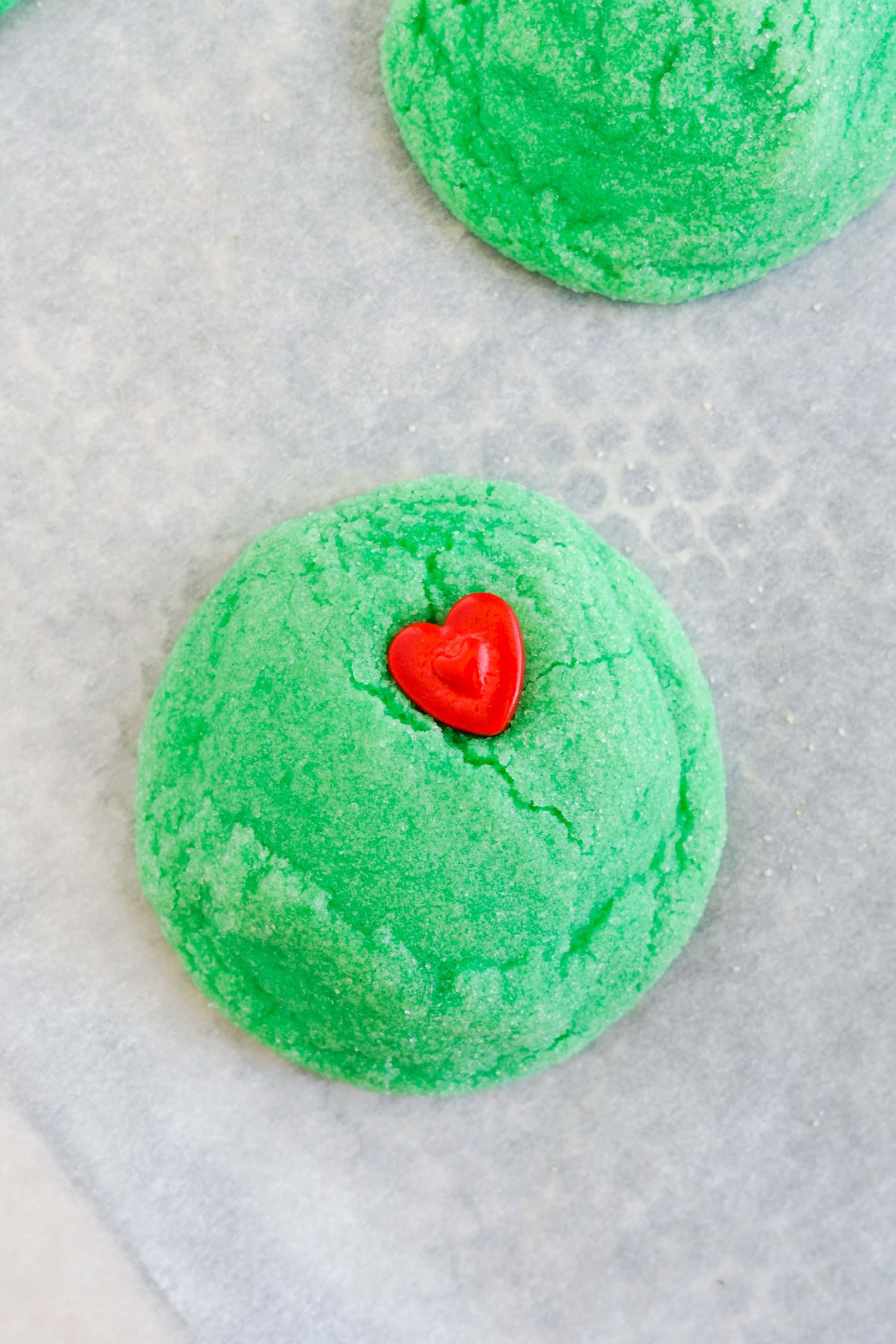 Grinch Sugar Cookies on parchment paper