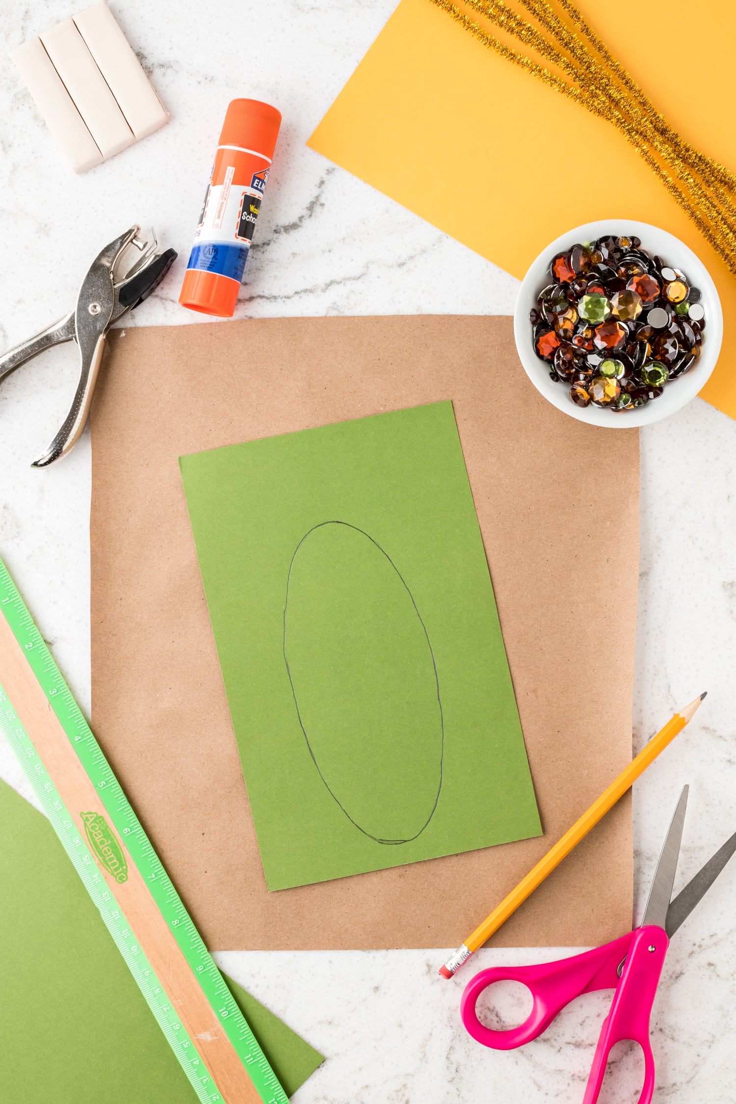 Tracing oval on green paper