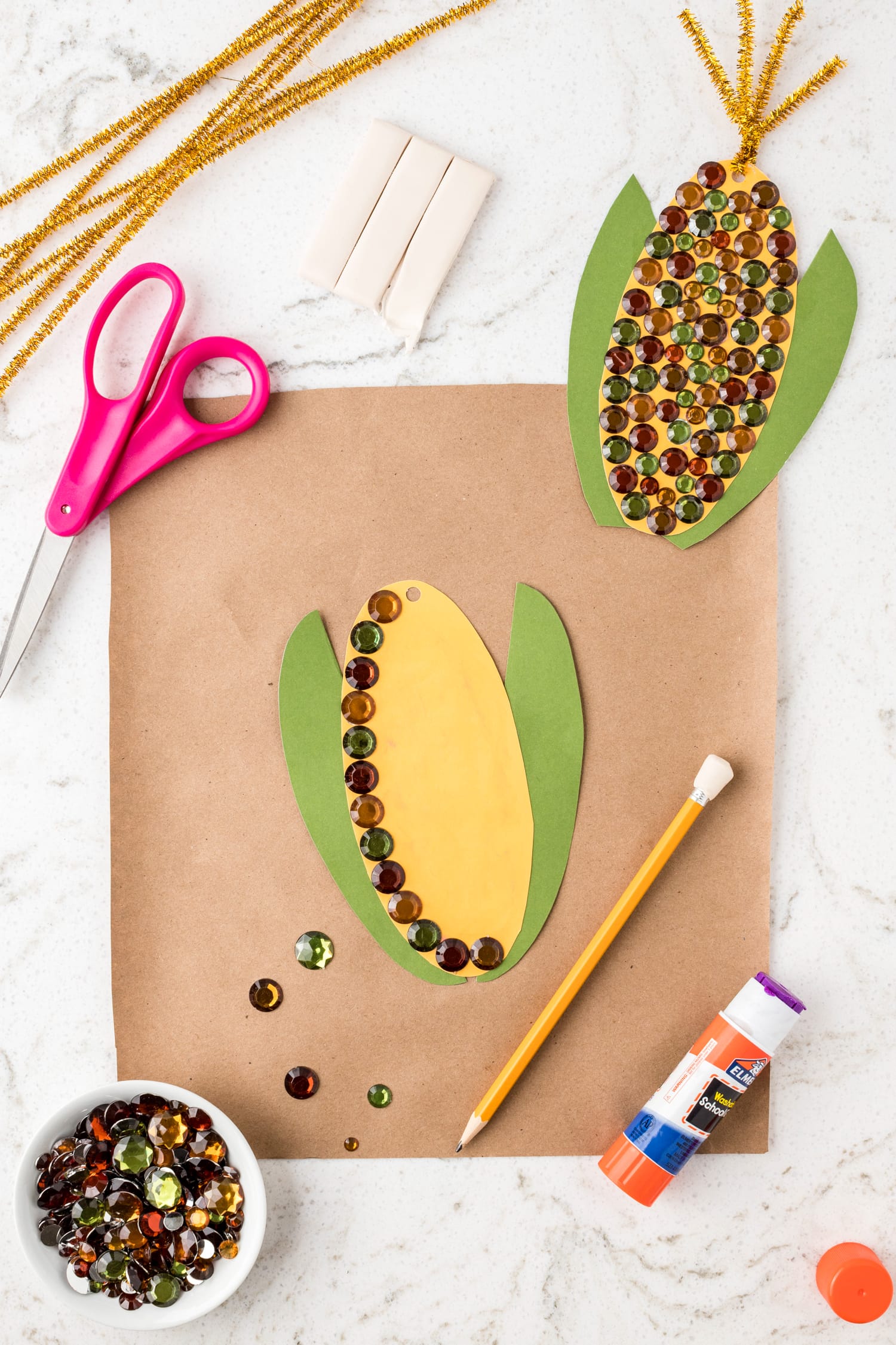 Putting gemstones on corn craft