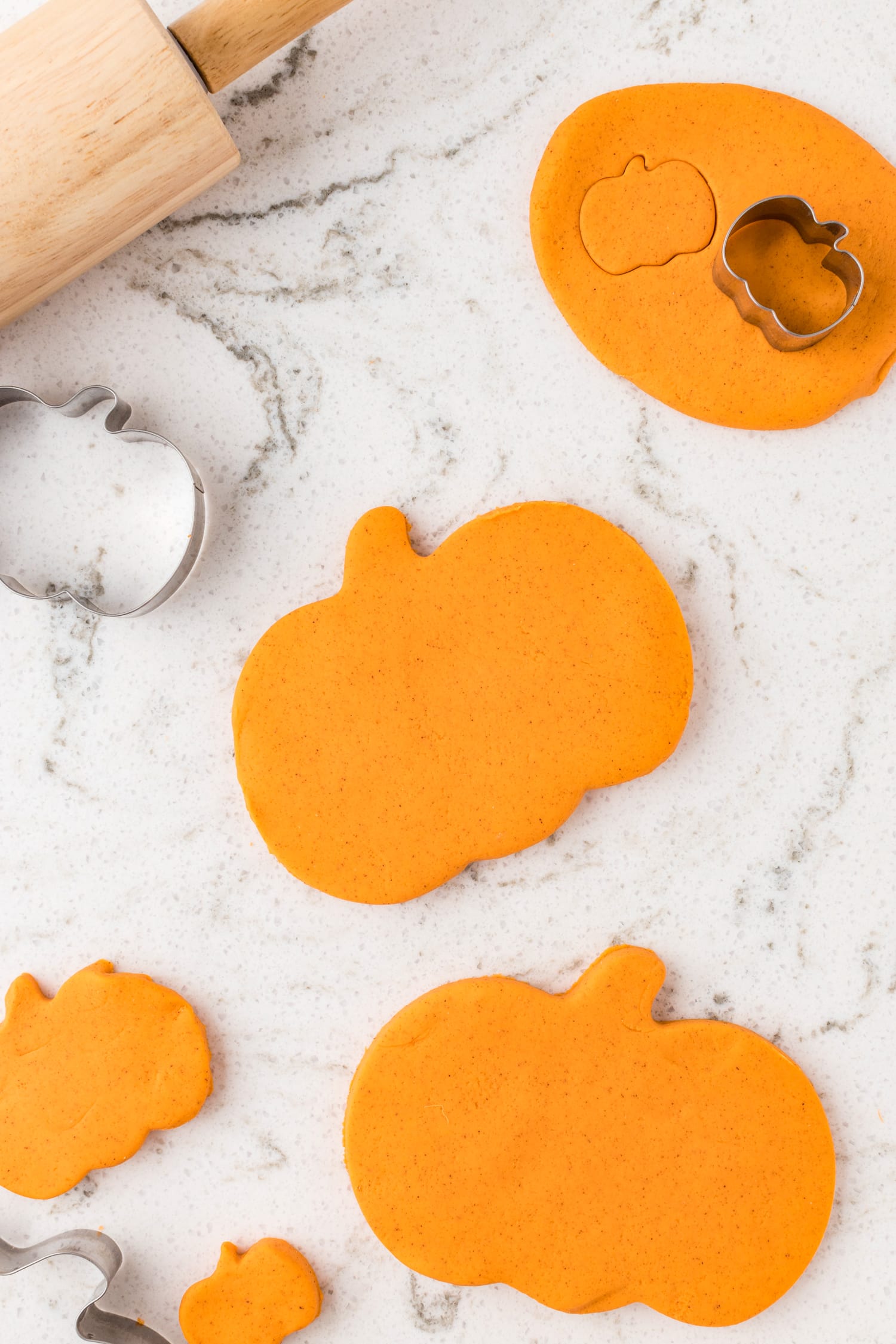Homemade pumpkin playdough cut into pumpkin shapes