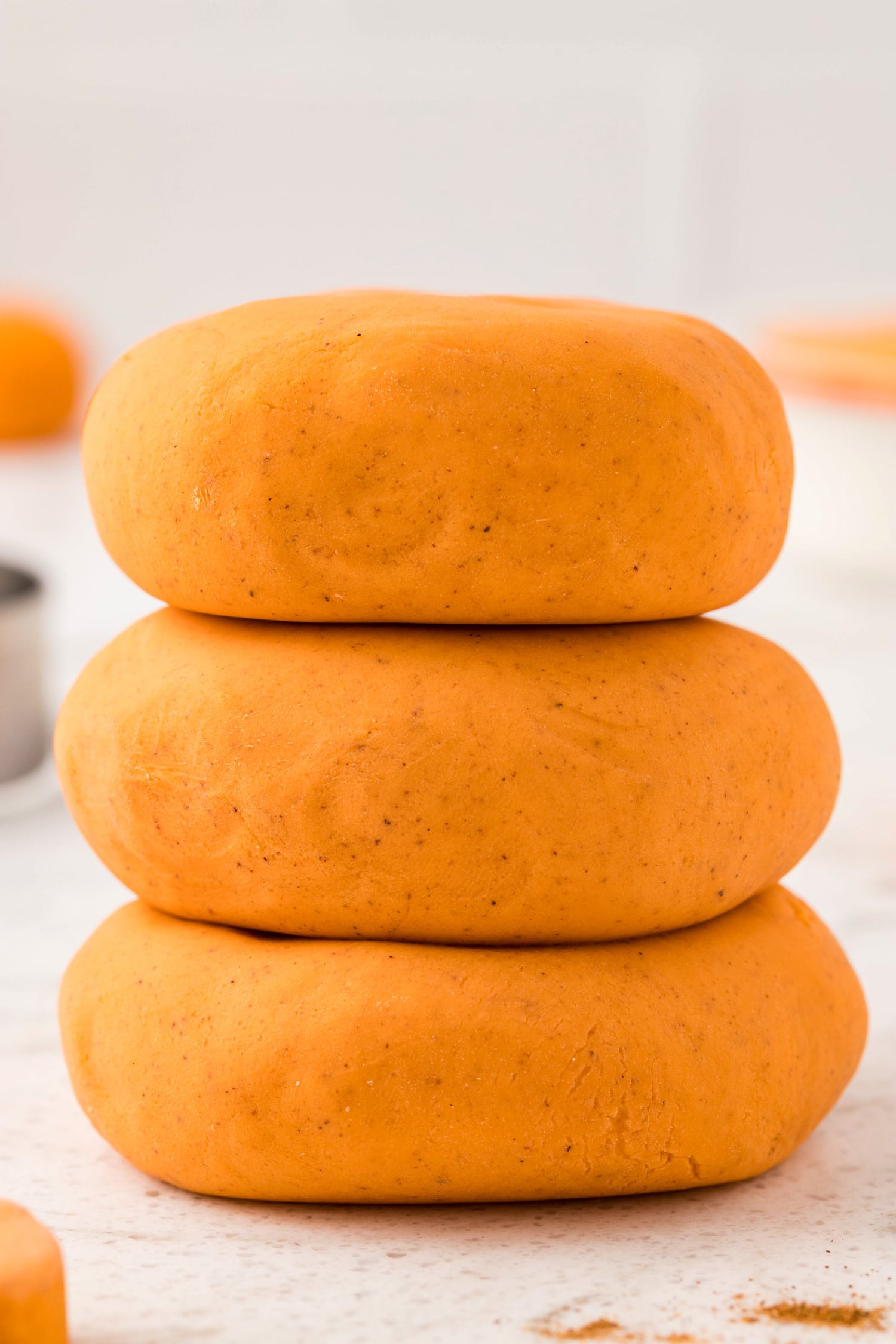 Stack of three flatted pumpkin spice playdough balls