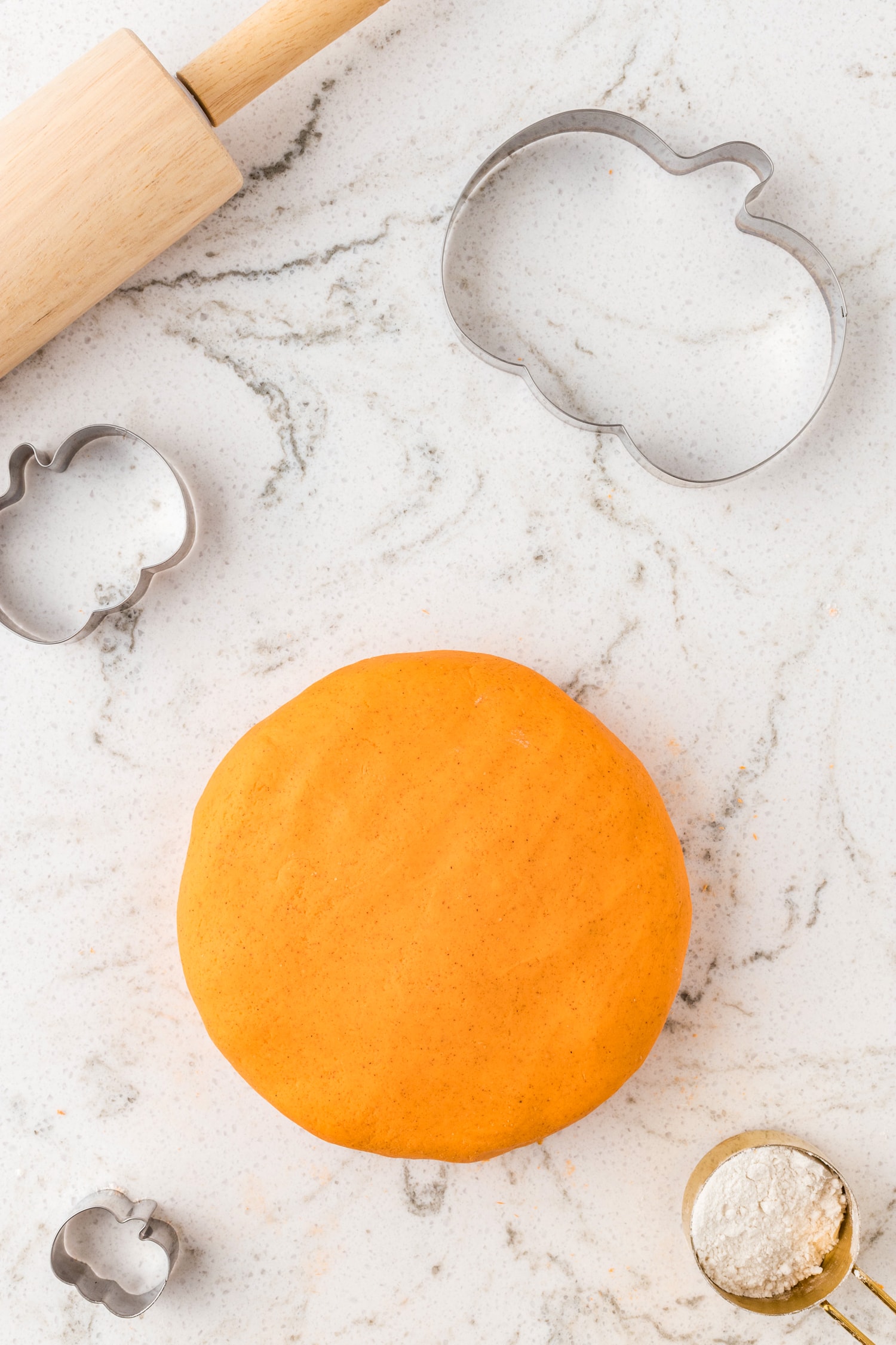 Orange playdough kneaded into a ball