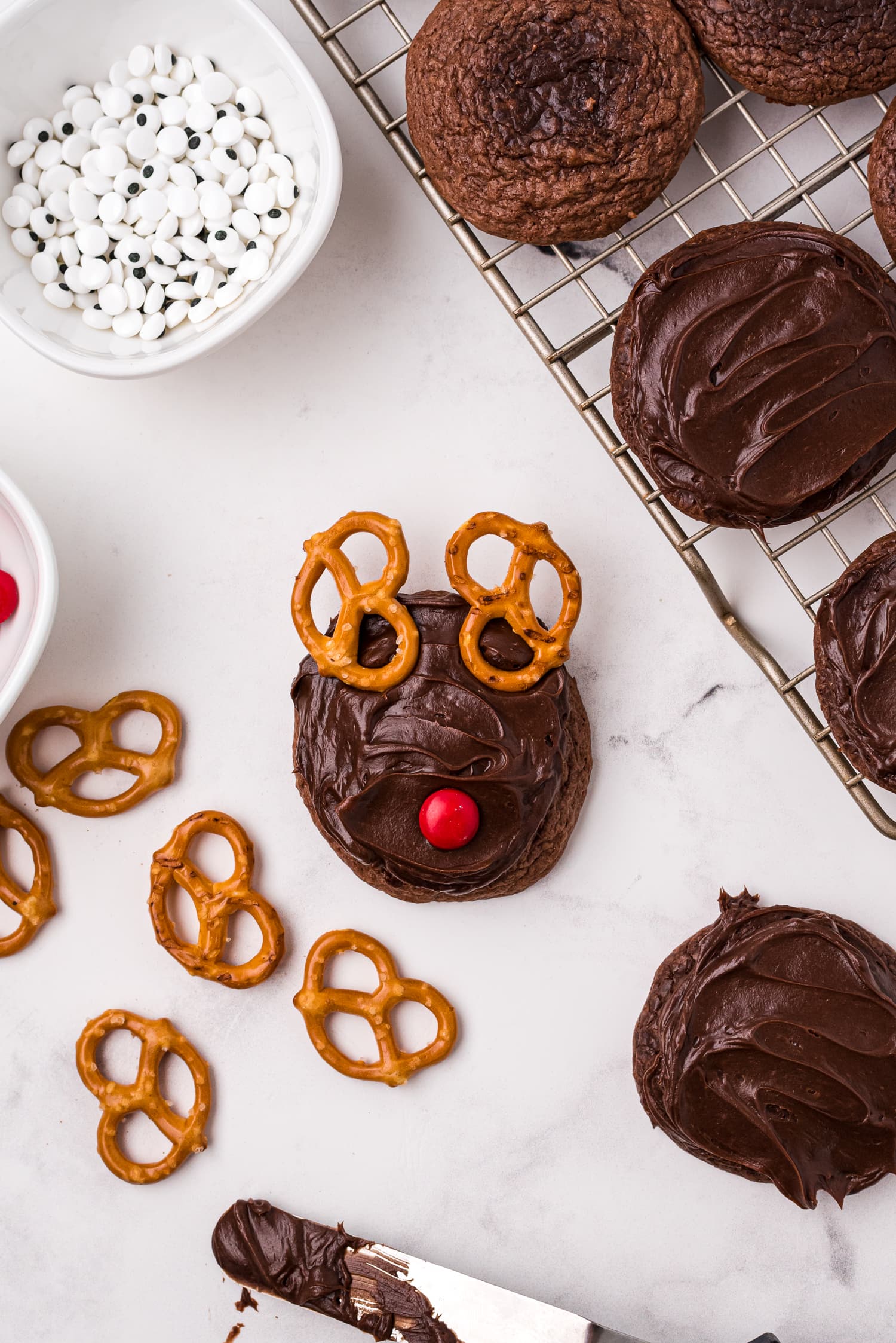 Chocolate cookie with pretzels for antlers and M&M for nose