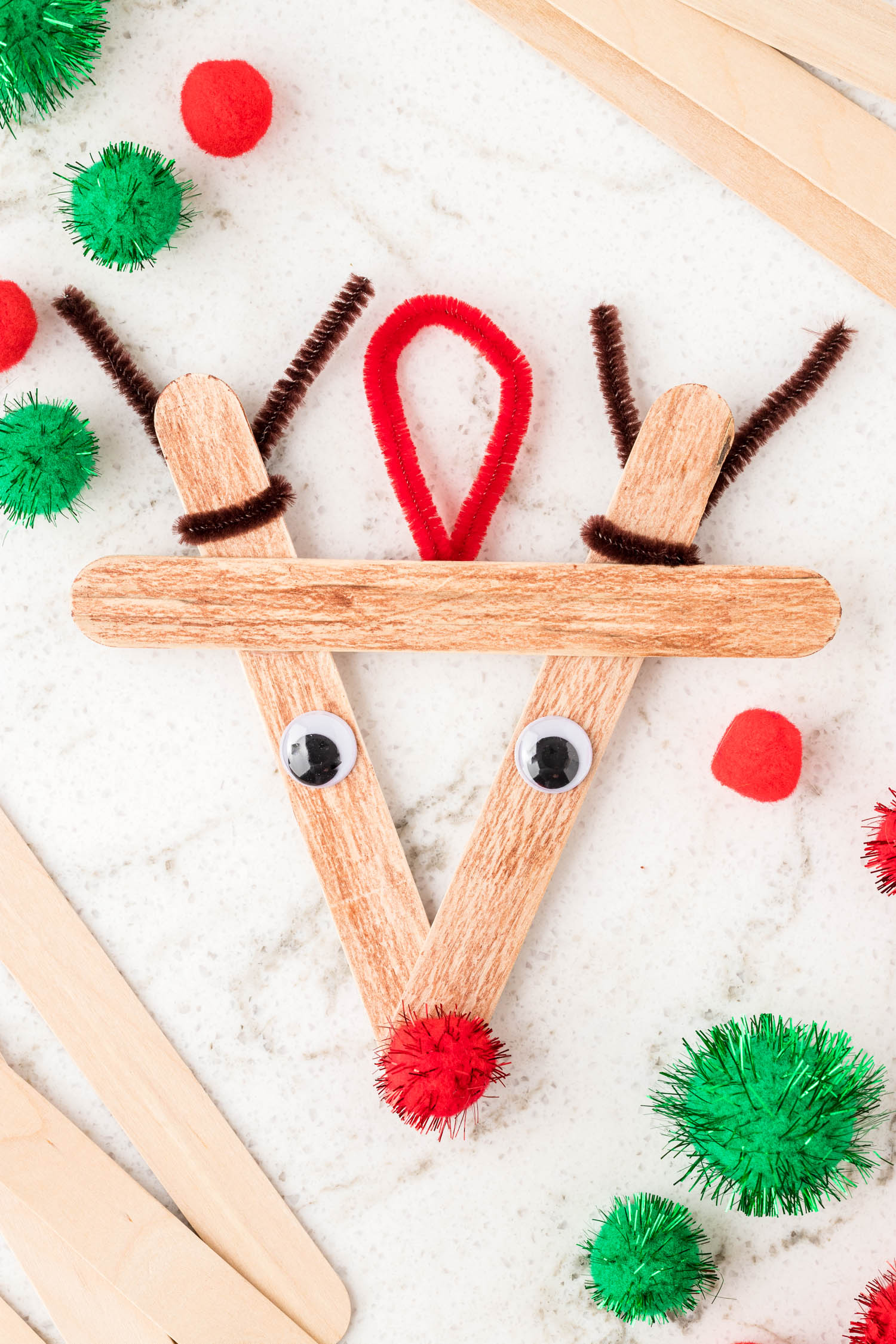 Reindeer Popsicle Stick Ornament on marble background