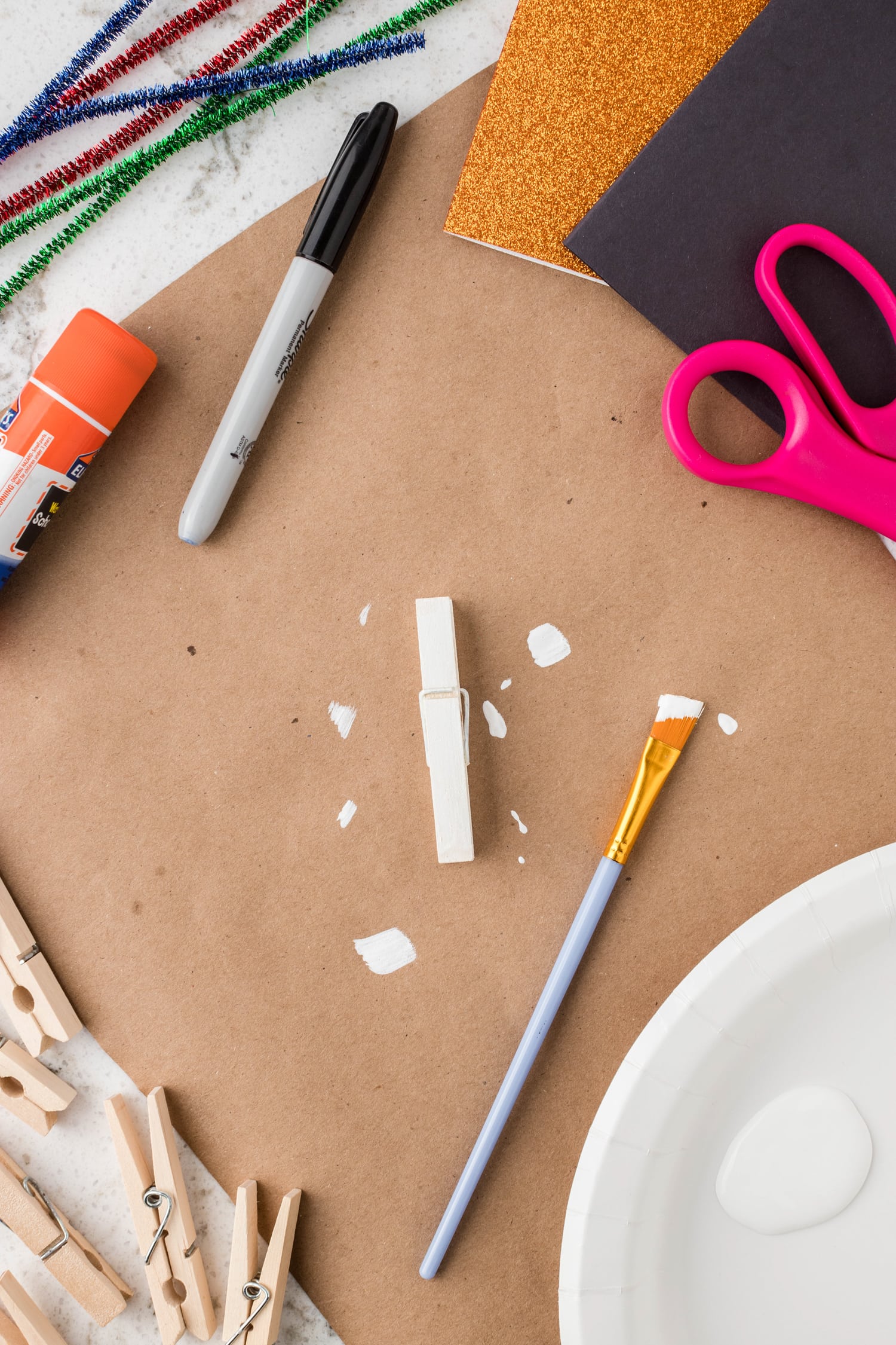 Painting a clothes pin white