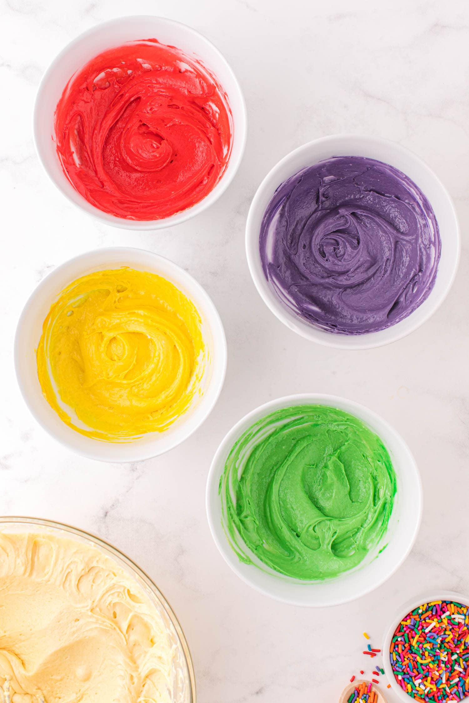 Divide the cake mix into separate bowls and add food coloring