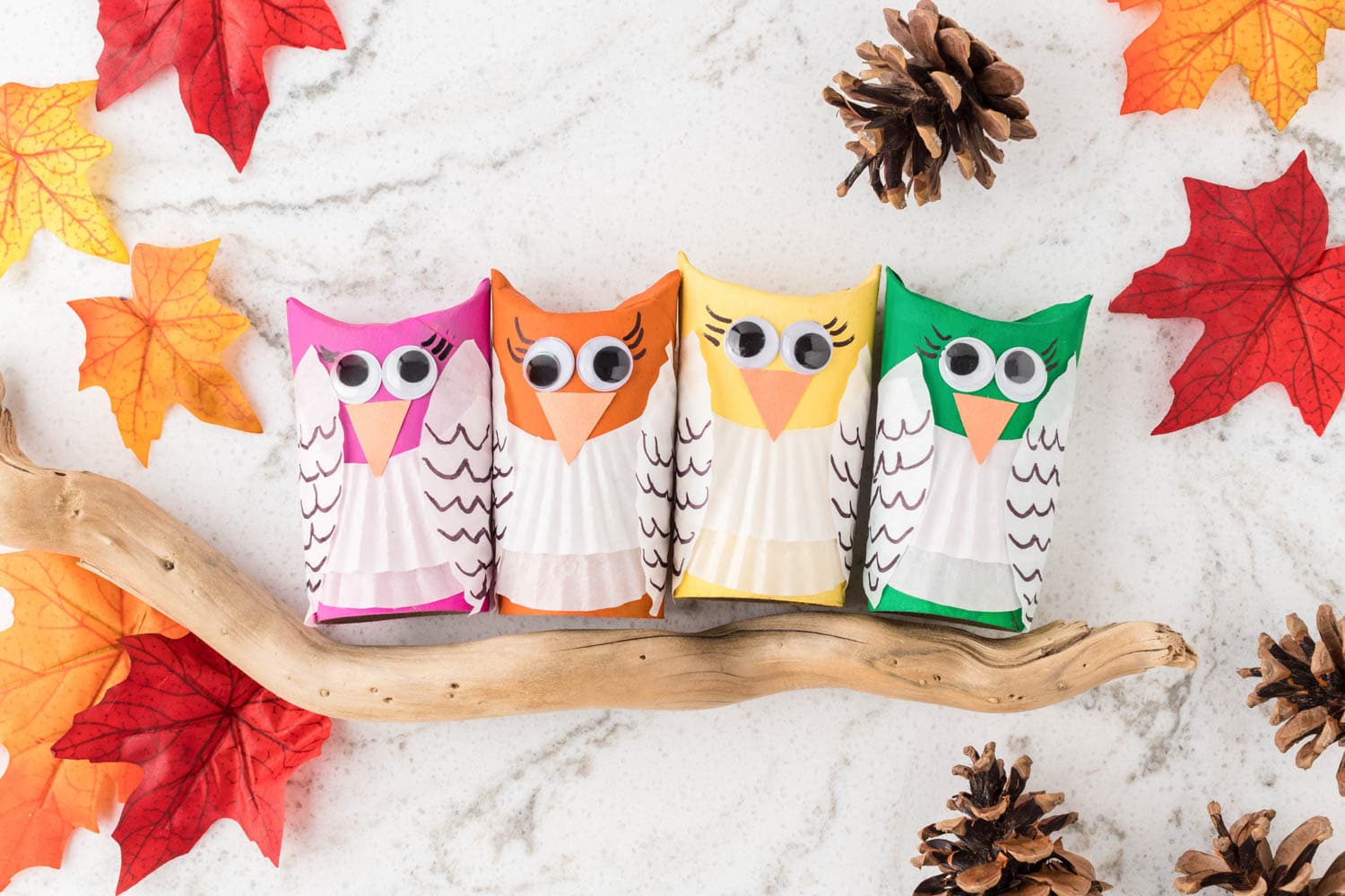 a Photo of Four Completed Owl Crafts Sitting on a Stick