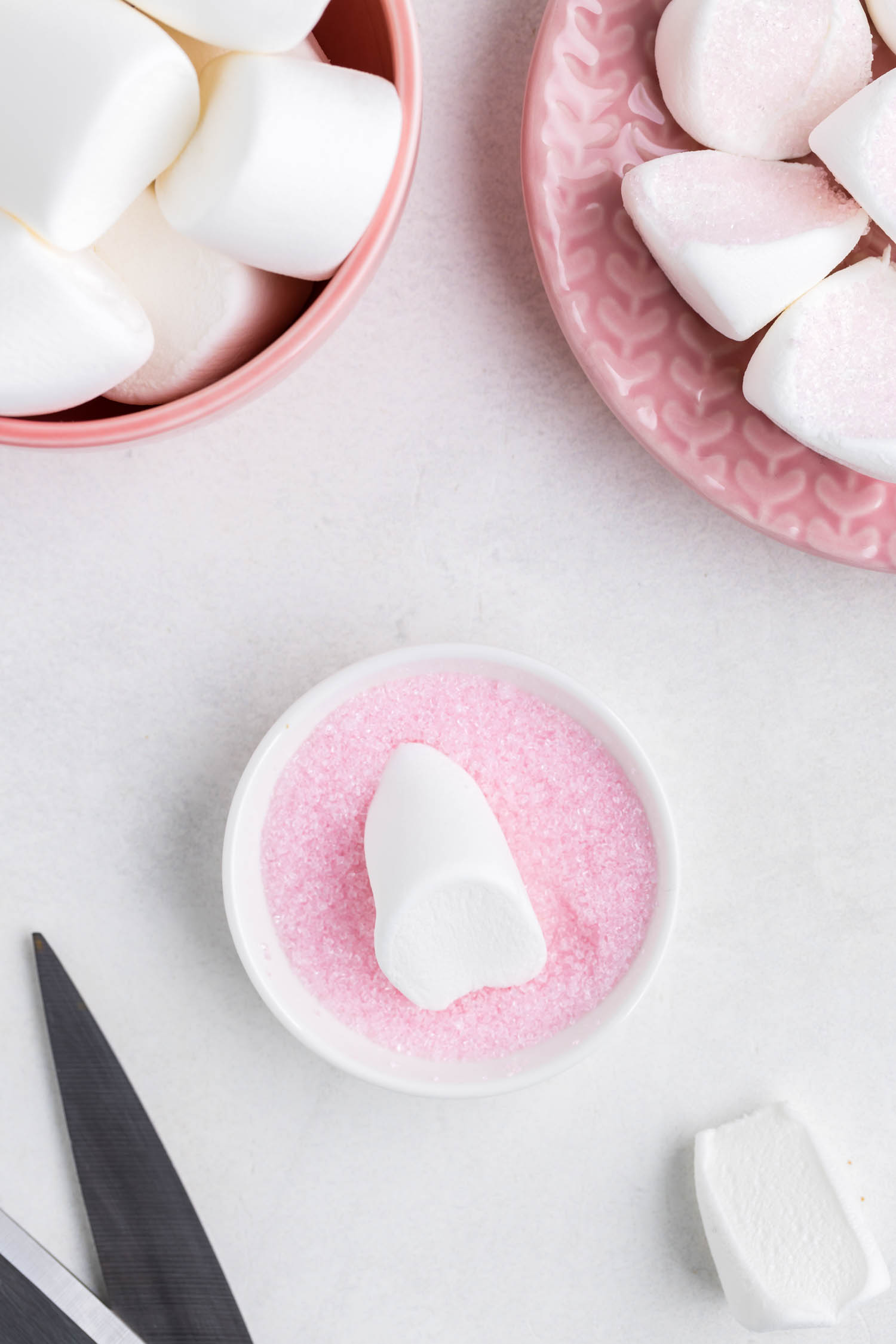 cut Large marshmallows in half diagonally and dip into pink sanding sugar for the bunny ears