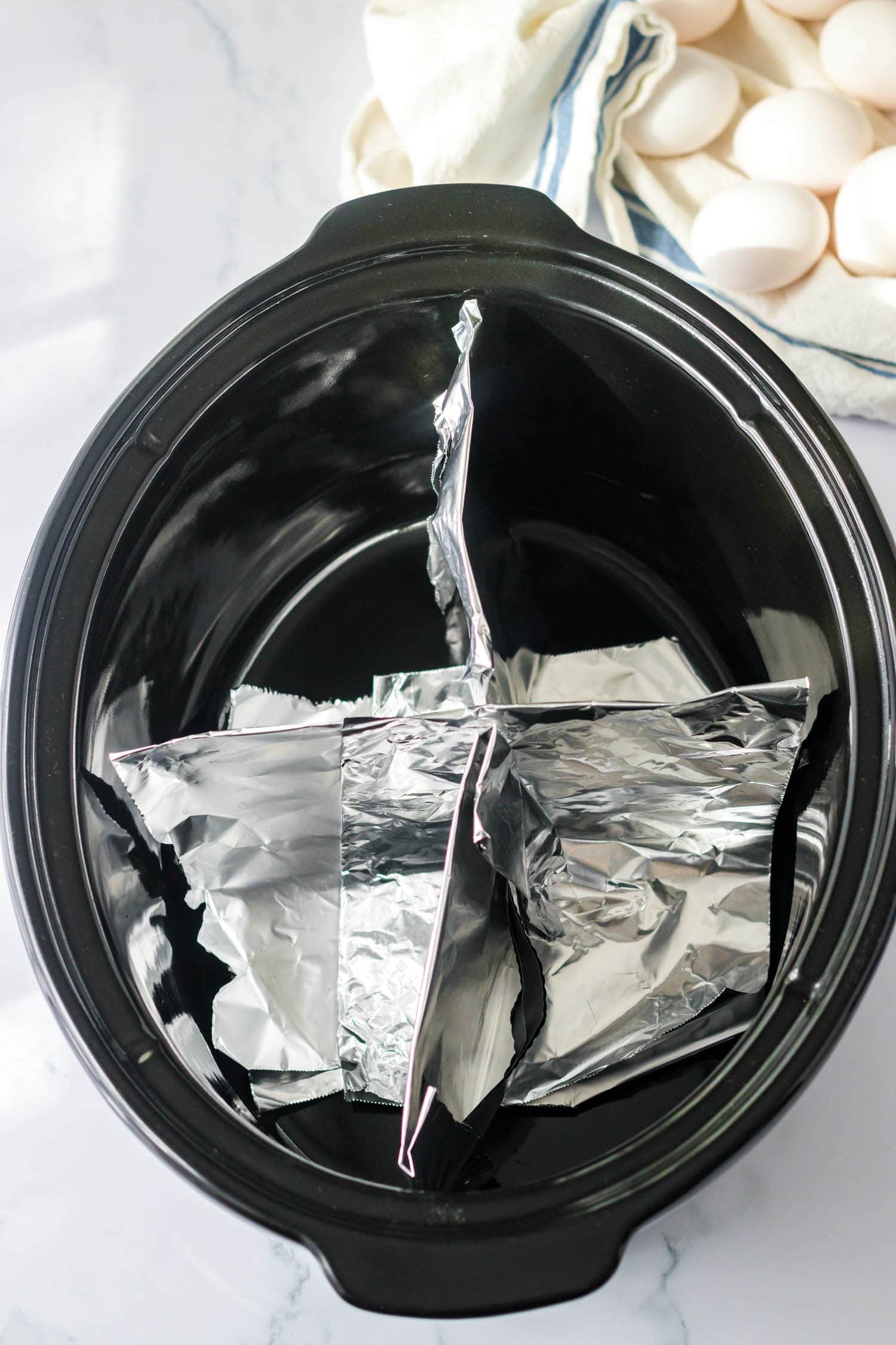Fold Over Pieces of Foil into Squares to make 4 sections in the crock pot