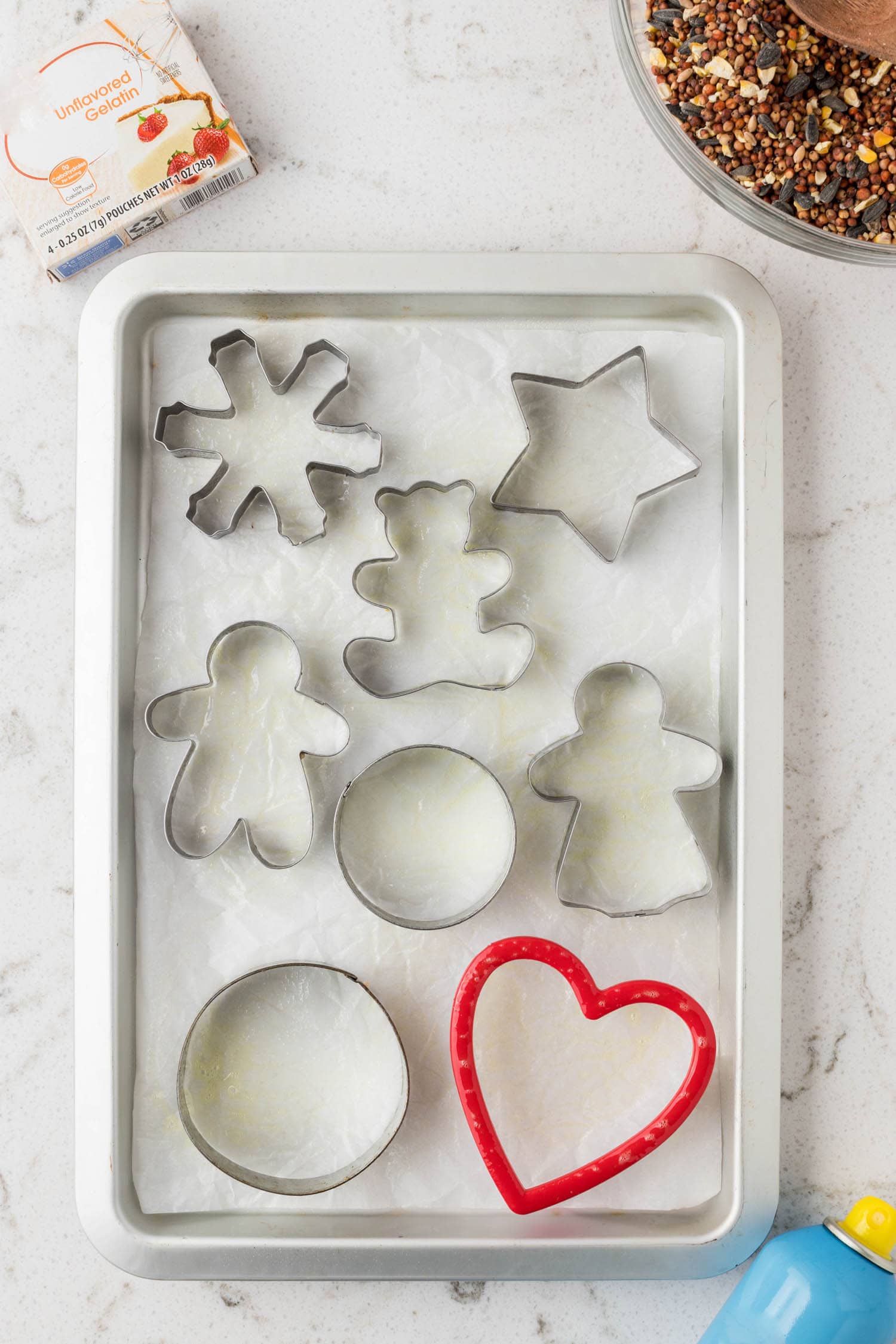 Lay down parchment paper on the cookie sheet and lay out your cookie cutters
