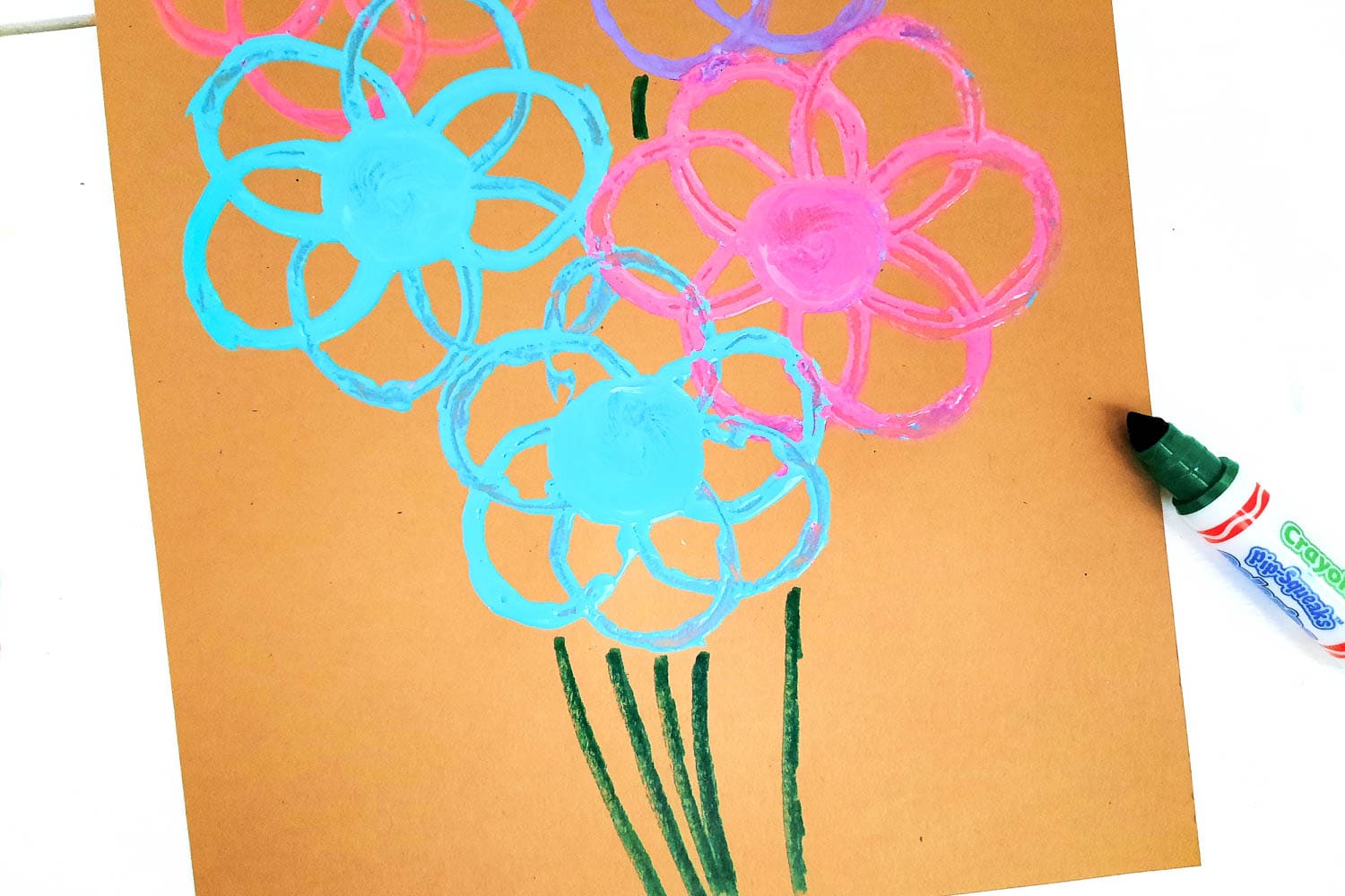 Next, Draw Stems on the Flowers with the Green Marker