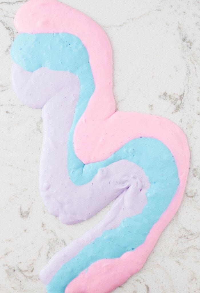 Lay Slime on the table in Strips to combine and mix Colors together.