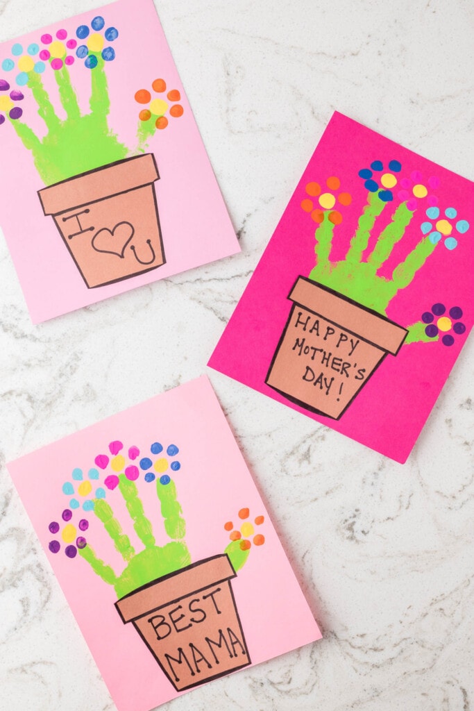 3 examples of Completed Handprint Flower Pot Crafts