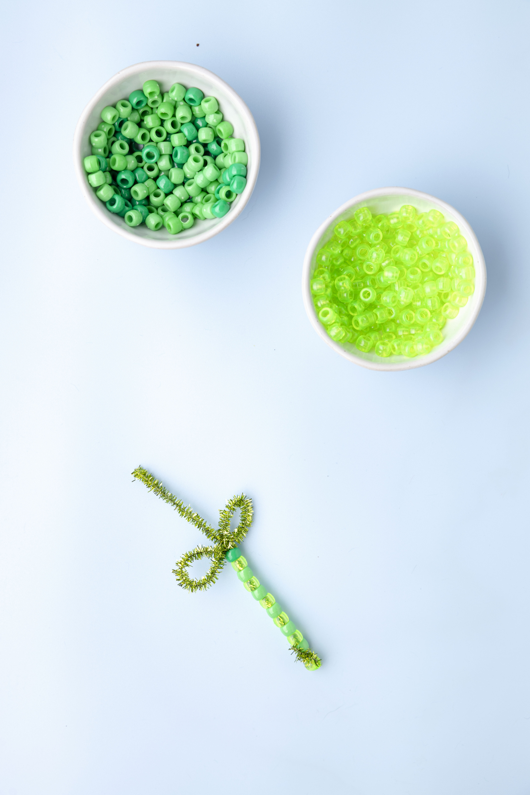 Loop the pipe cleaner above the last bead around your finger and twist to create the leaves