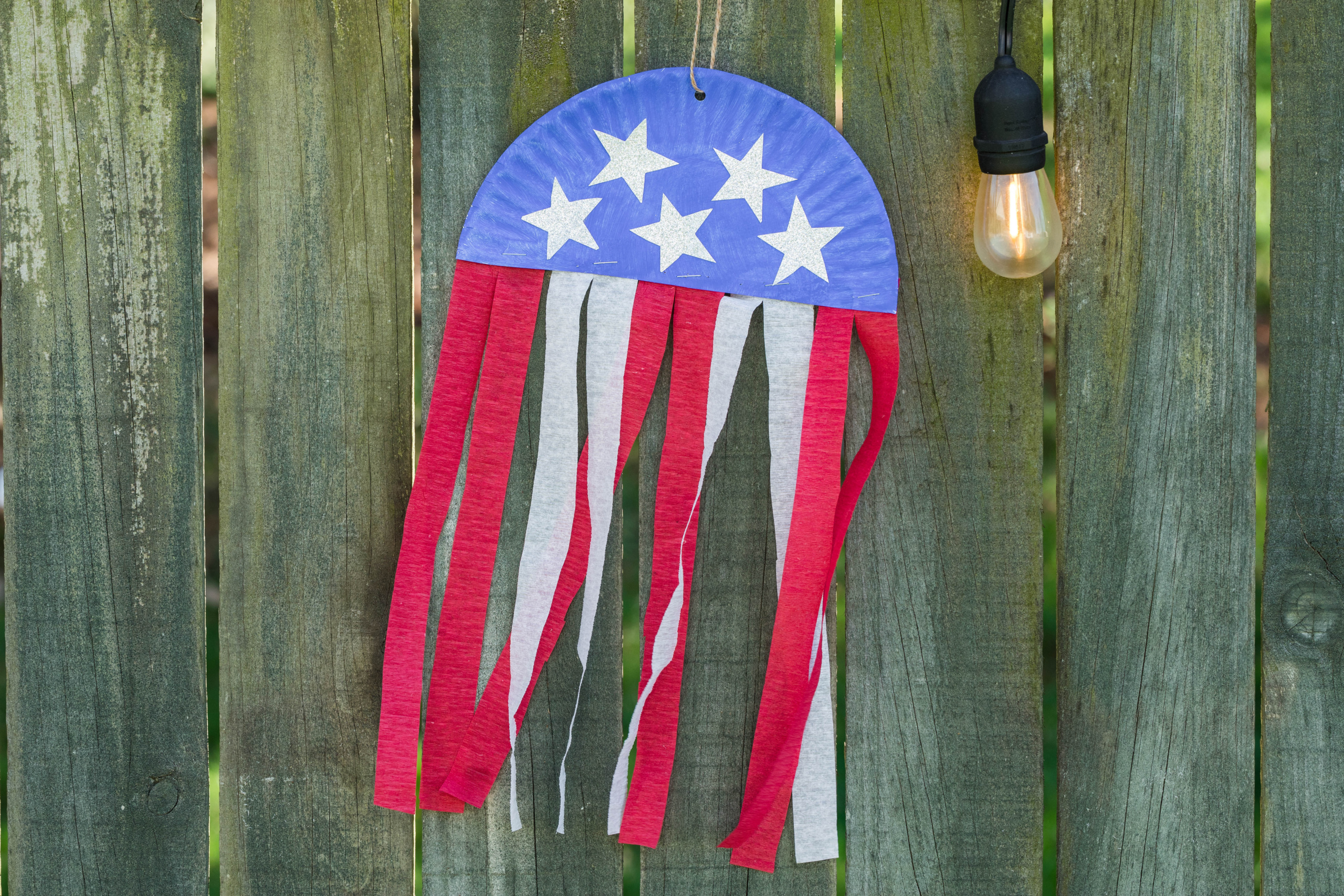 a Completed Flag Craft hanging on an Outside Fence.