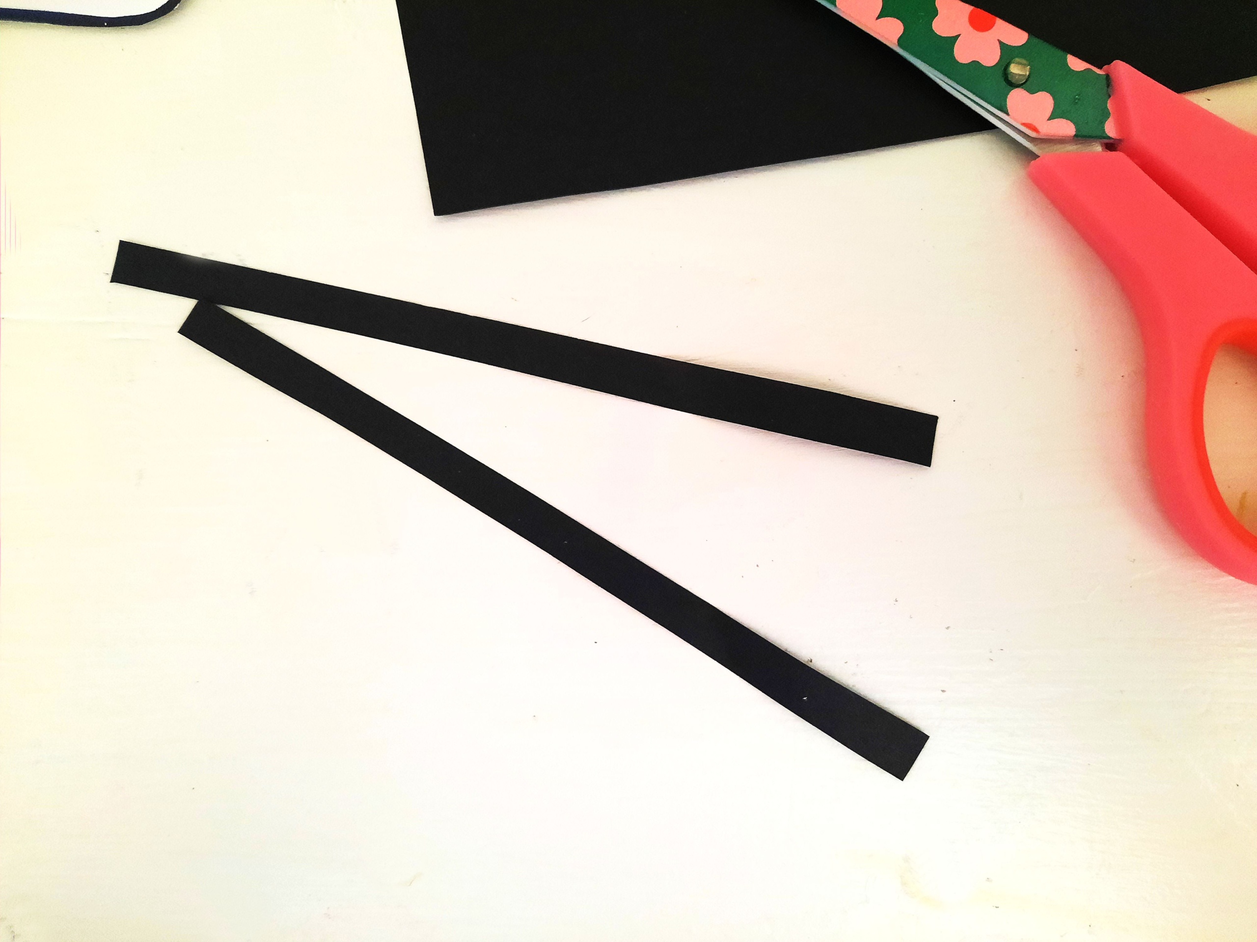 Cut skinny Strips of Black Paper to make the Antennas for the Bee