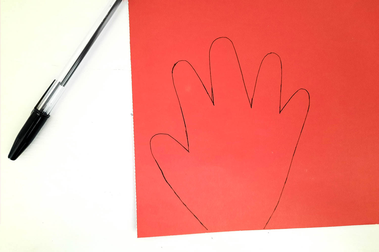 Trace your hand on red cardstock paper