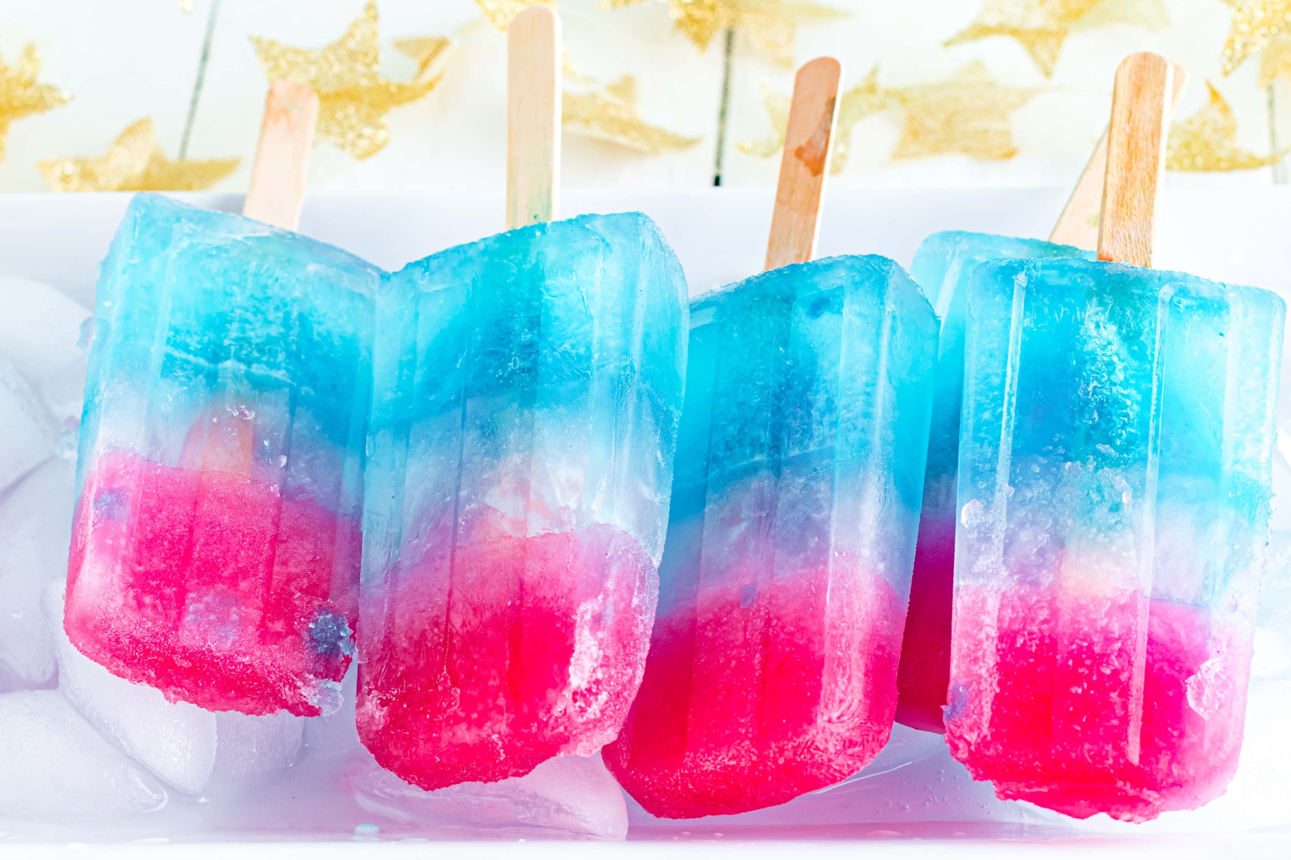 Completed Popsicles laying on a plate of ice