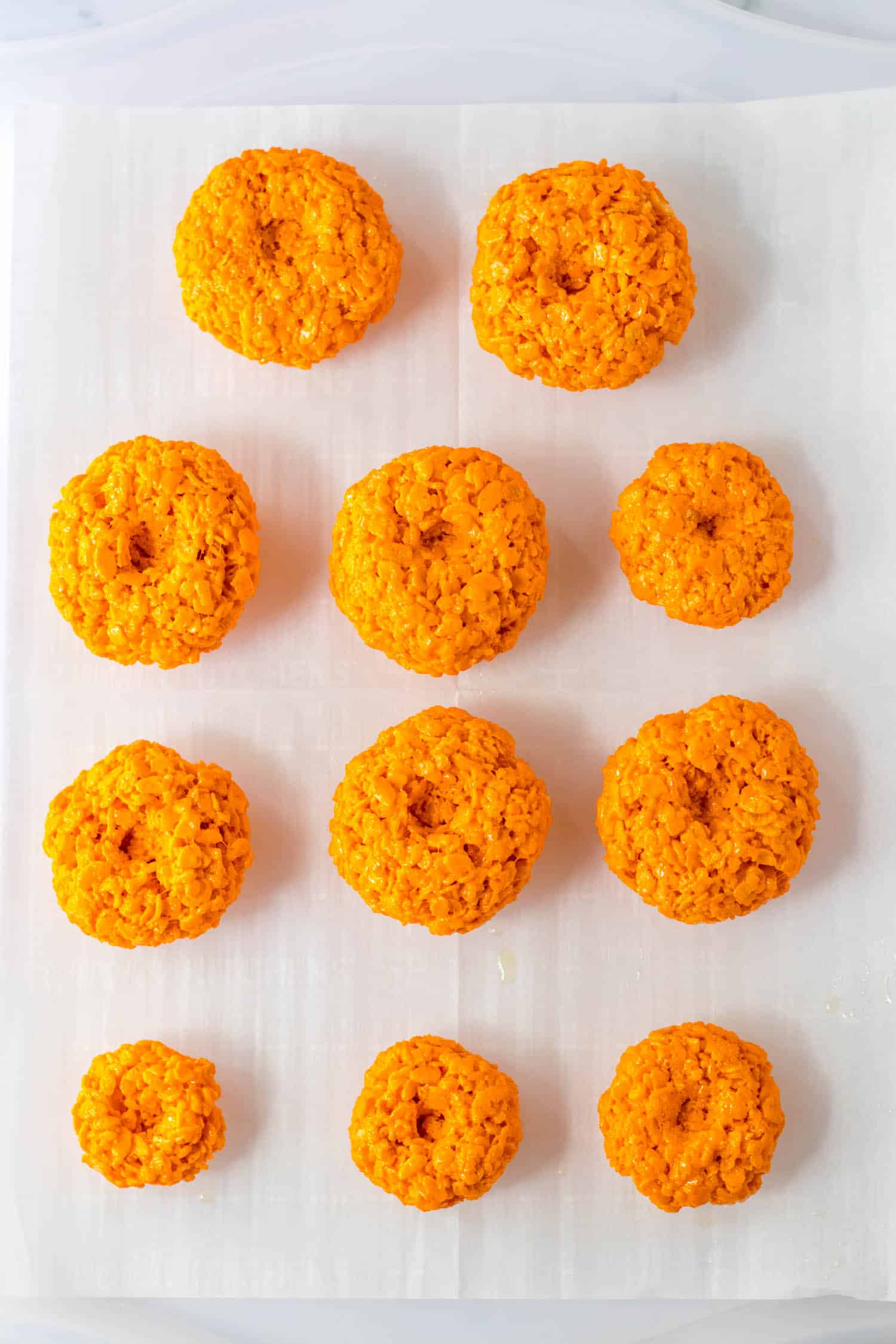 Spray hands with cooking spray and grab chunks of rice krispies and form into balls. Press down on the top and bottom to make it look like a pumpkin.