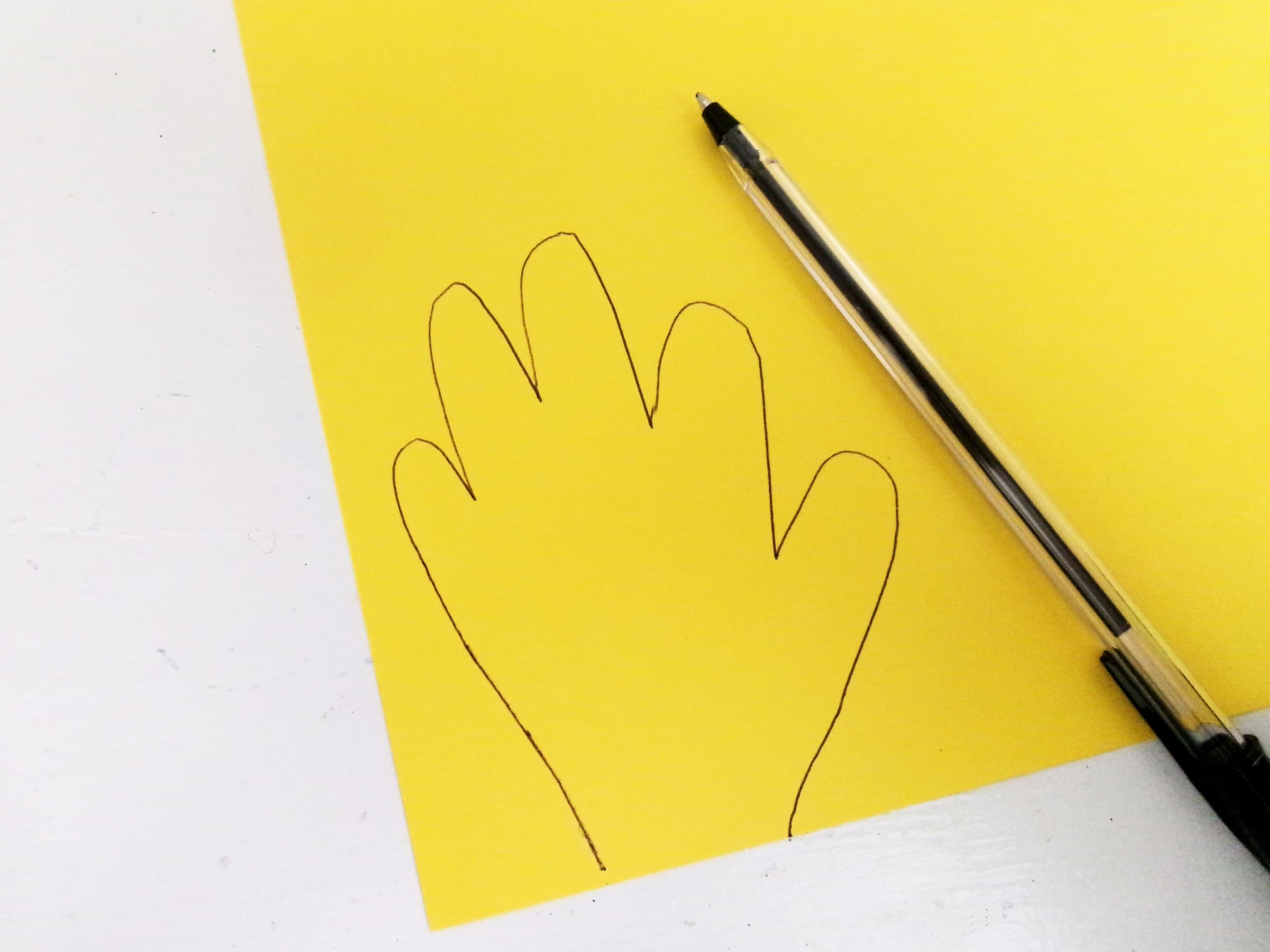 Trace handprints on yellow cardstock paper. will need 4.
