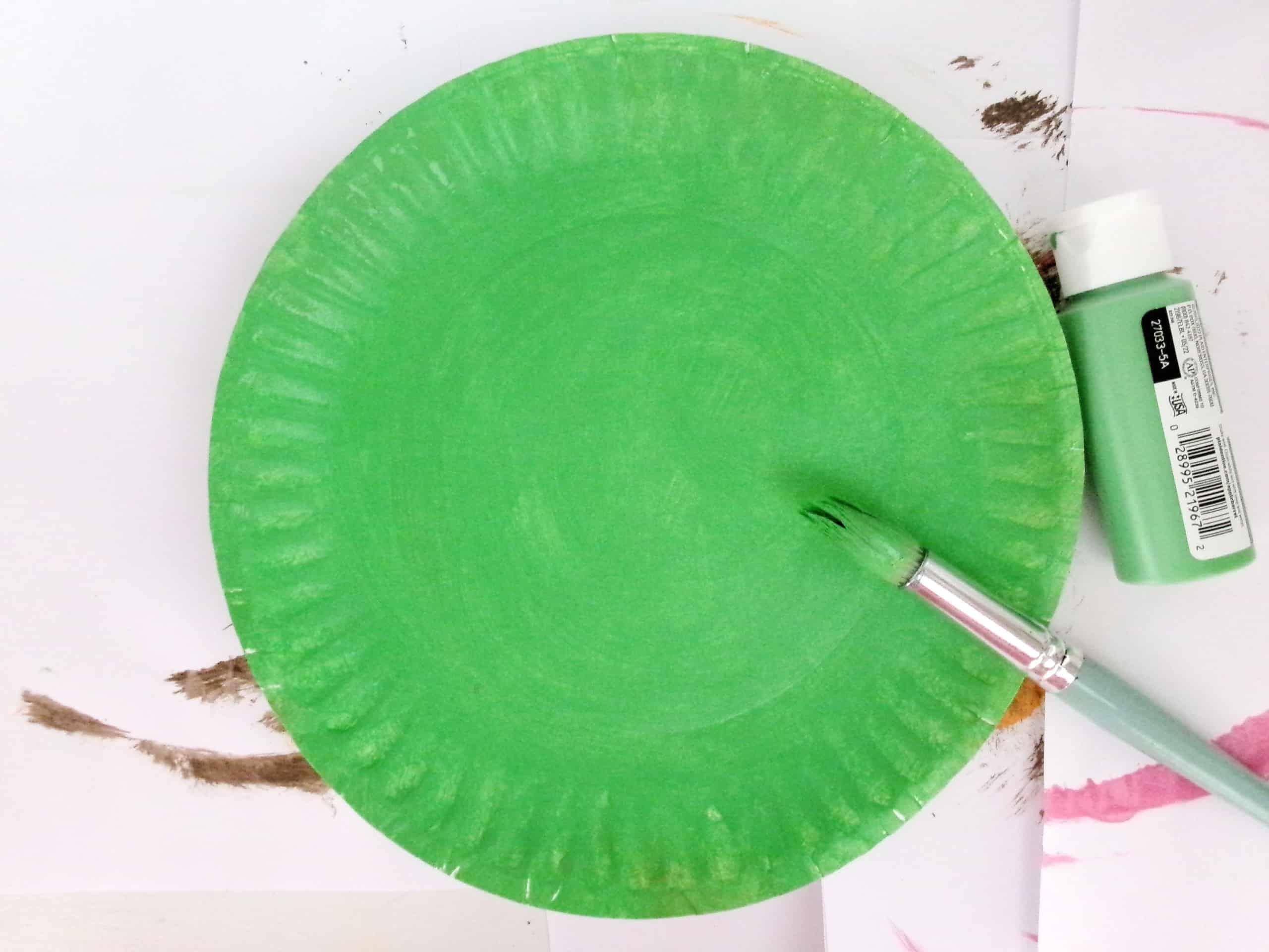Start by Painting a Paper Plate Green.