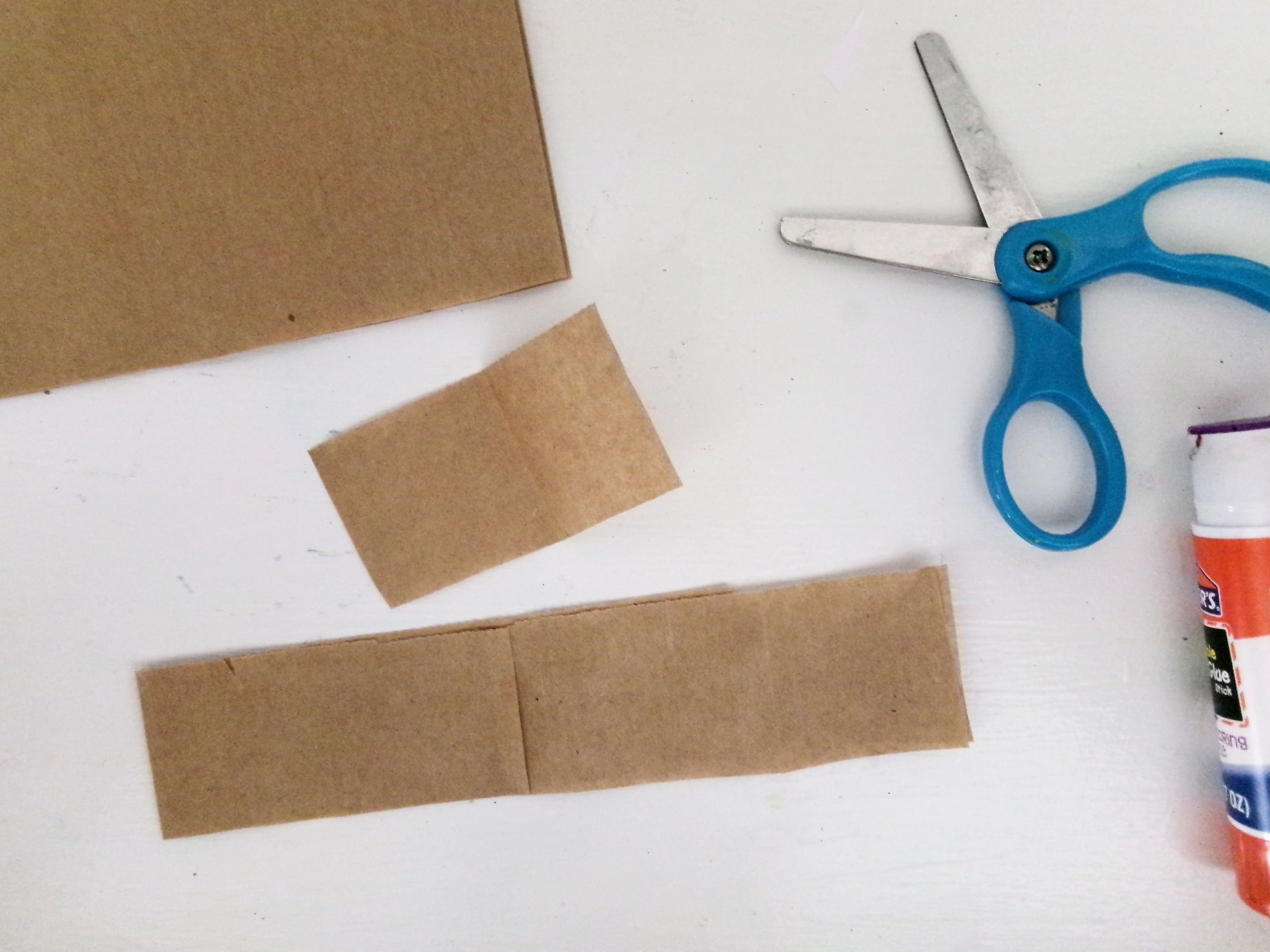 Fold the strip in half and Measure for it to fit the bottom flap of the top of the bag. Cut away excess of the strip.