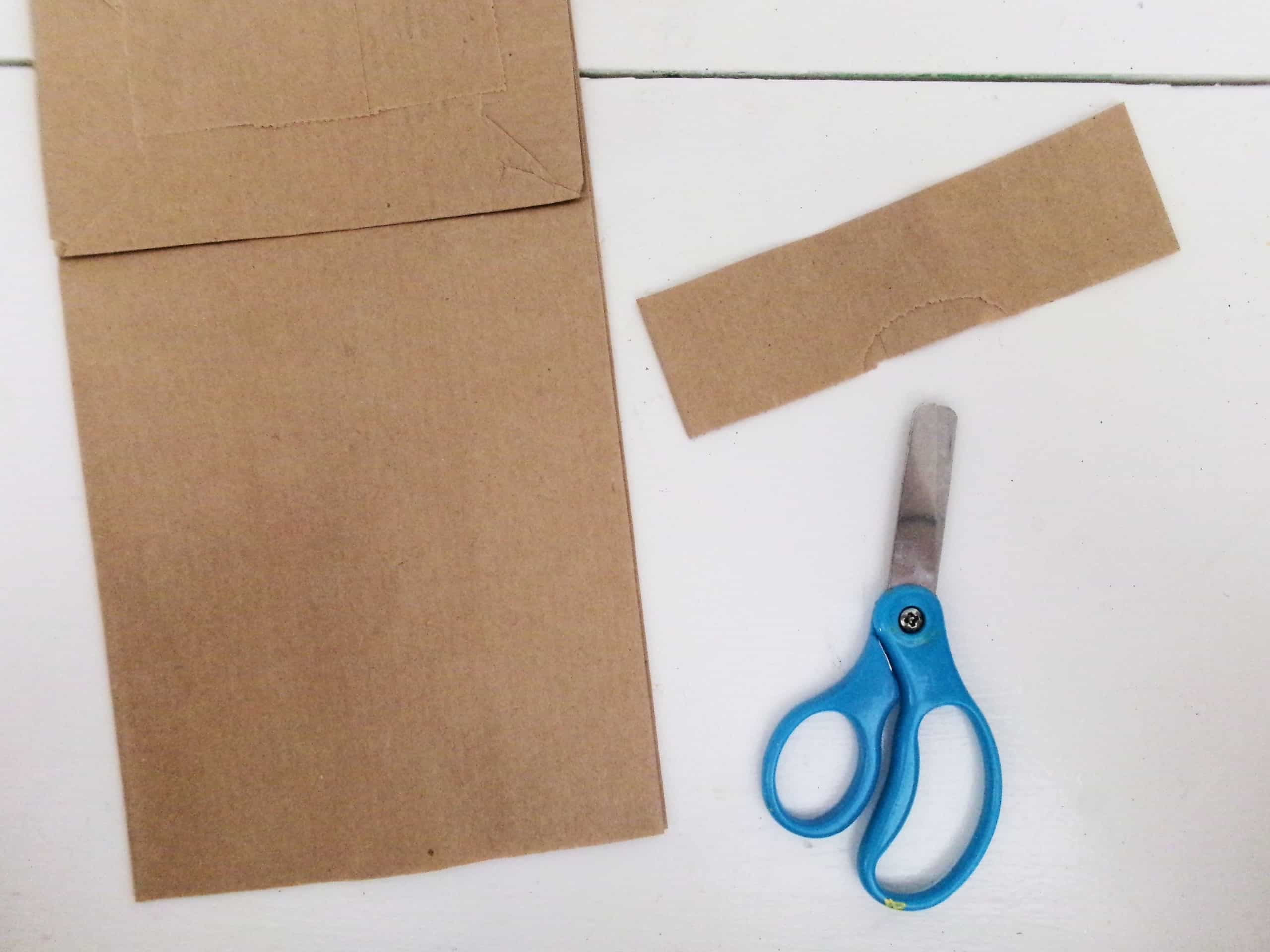 With the Flap of the Bag Being the Top, cut roughly 1 1/2" Strip off the Bottom of the Paper Bag.