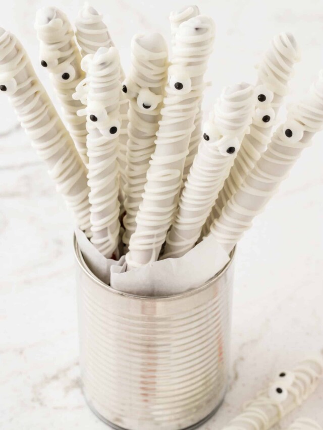 Mummy Pretzel Rods displayed in a tin can standing up.
