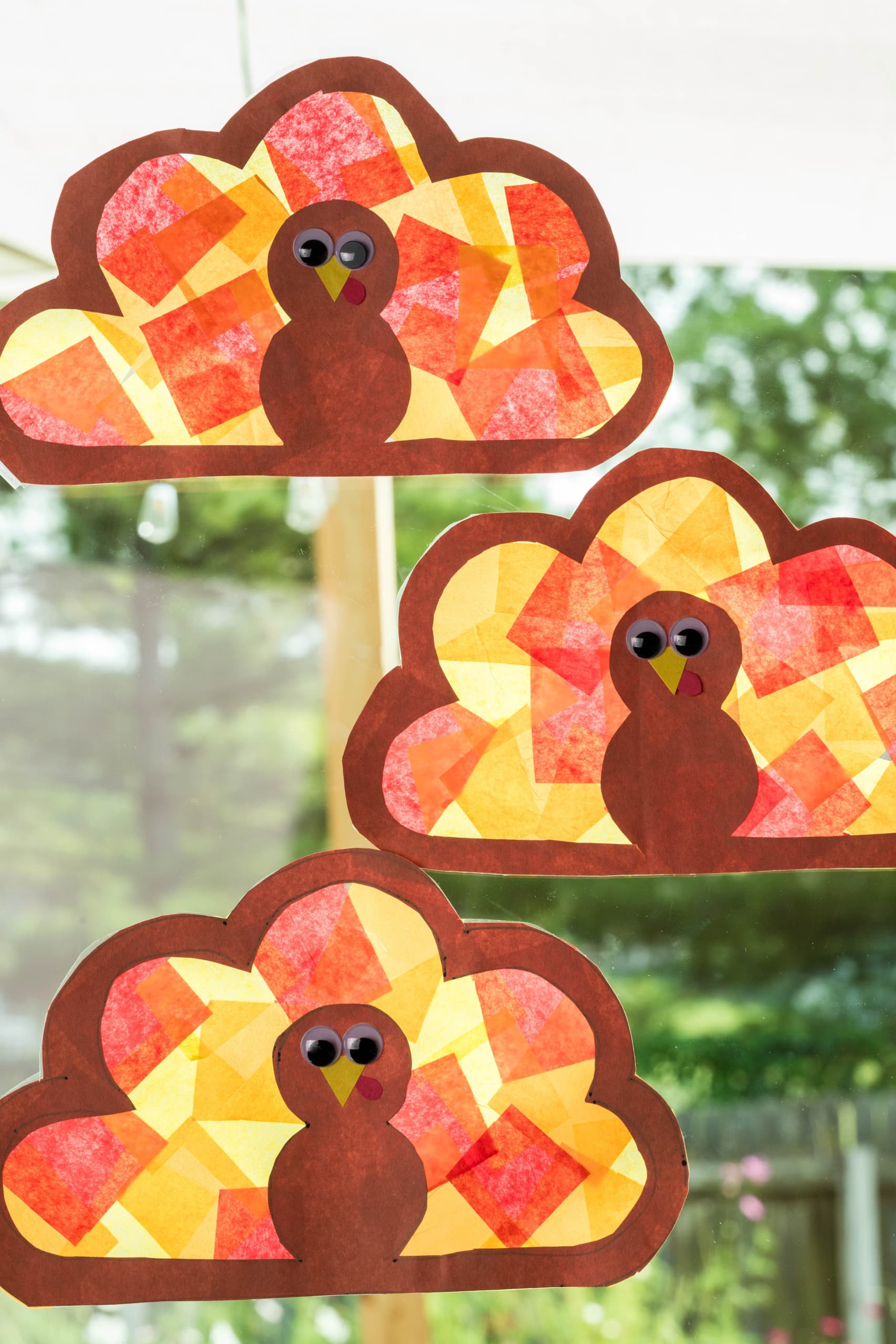 Three Suncatchers displayed in a window.