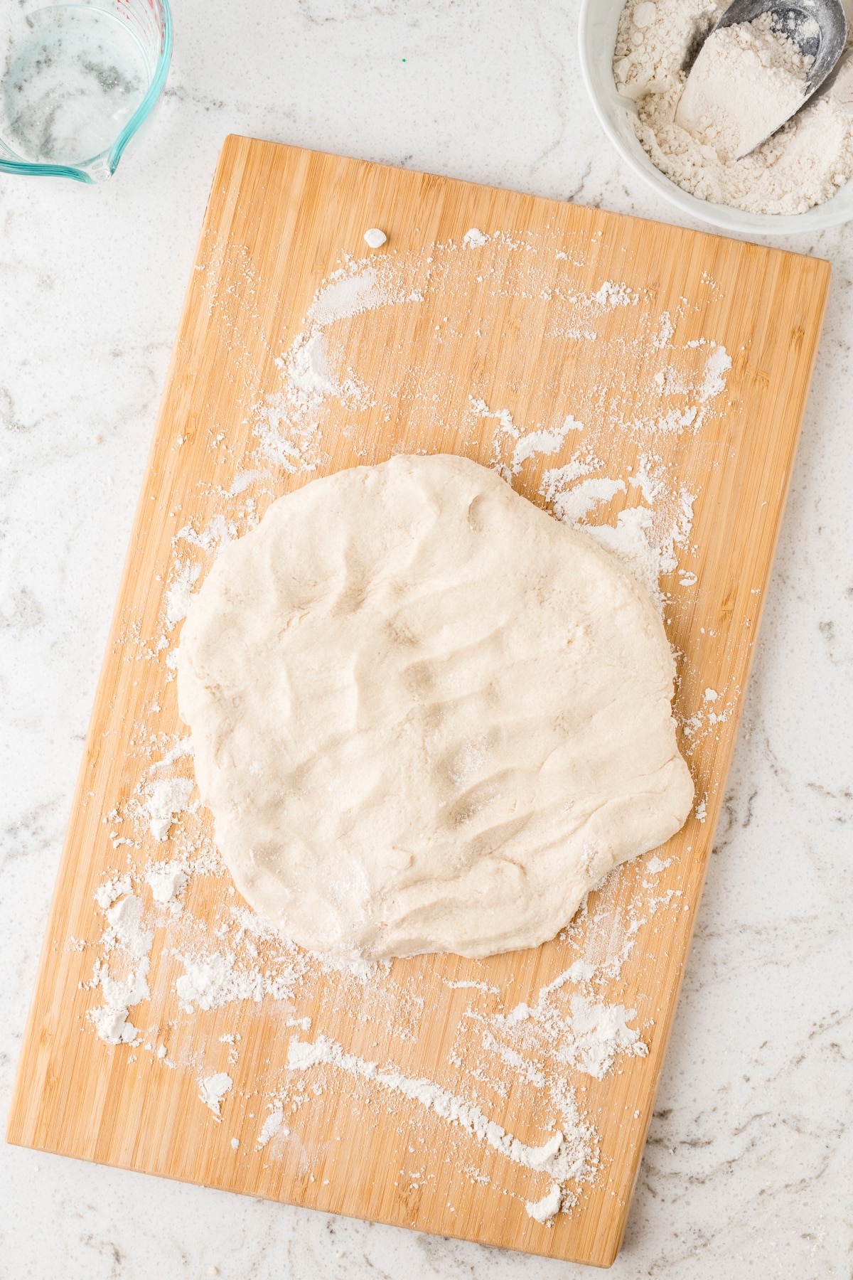 Dough flattened and ready to be rolled to be cut with cookie cutters.