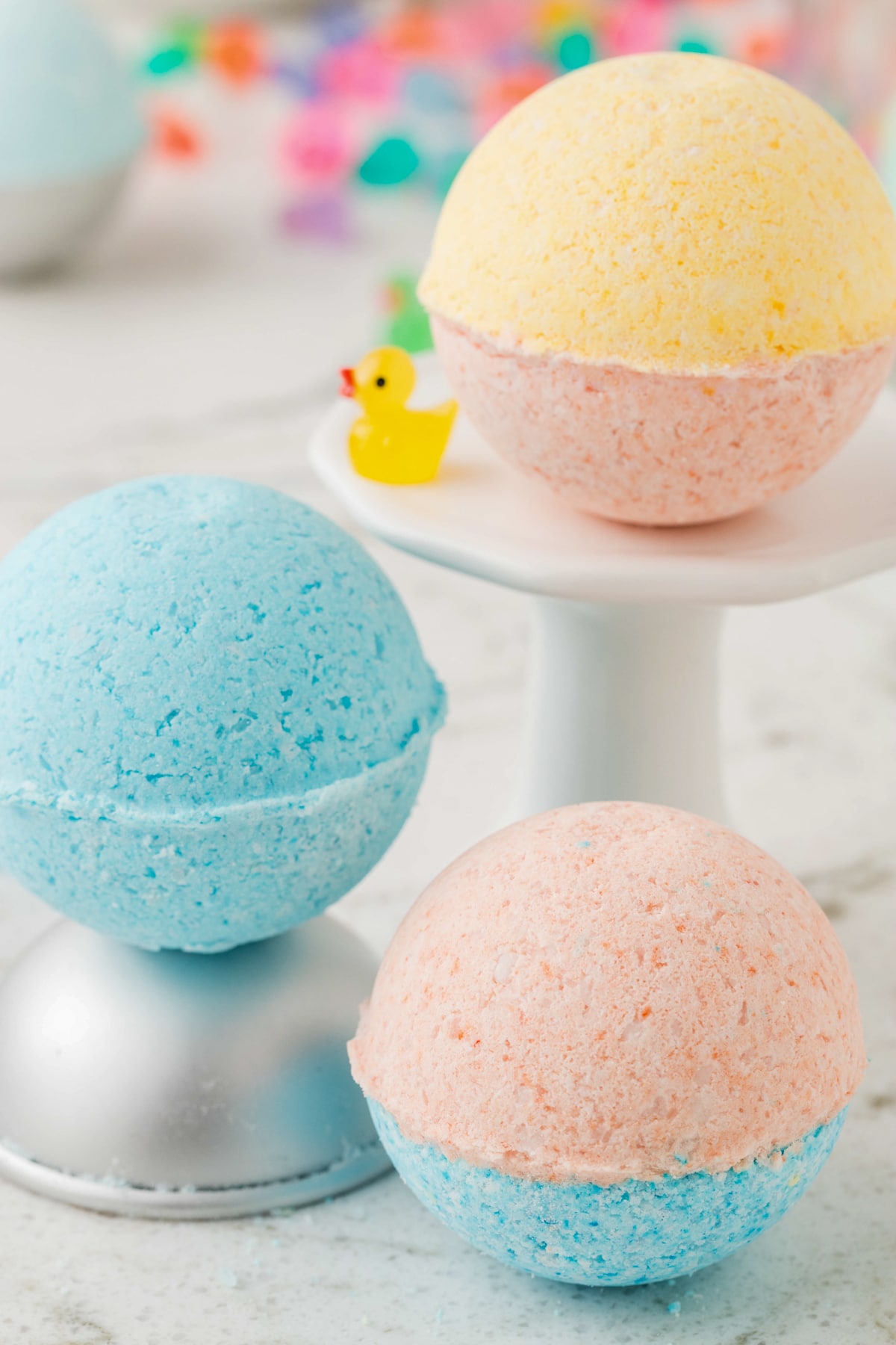 Bath bombs displayed on a stand and table.