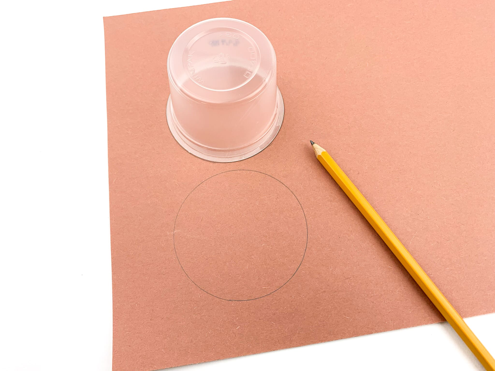 Using the bottom of the cup, trace out 3 circles.