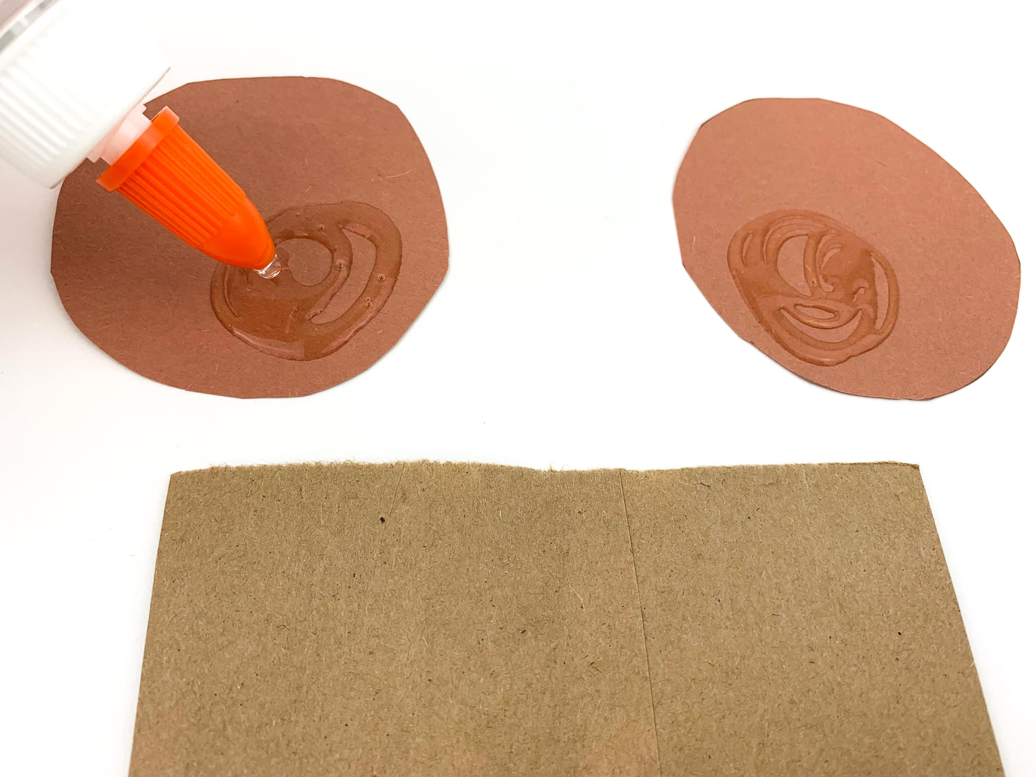 Glue two circles at the top of the bag on the back side for the ears.